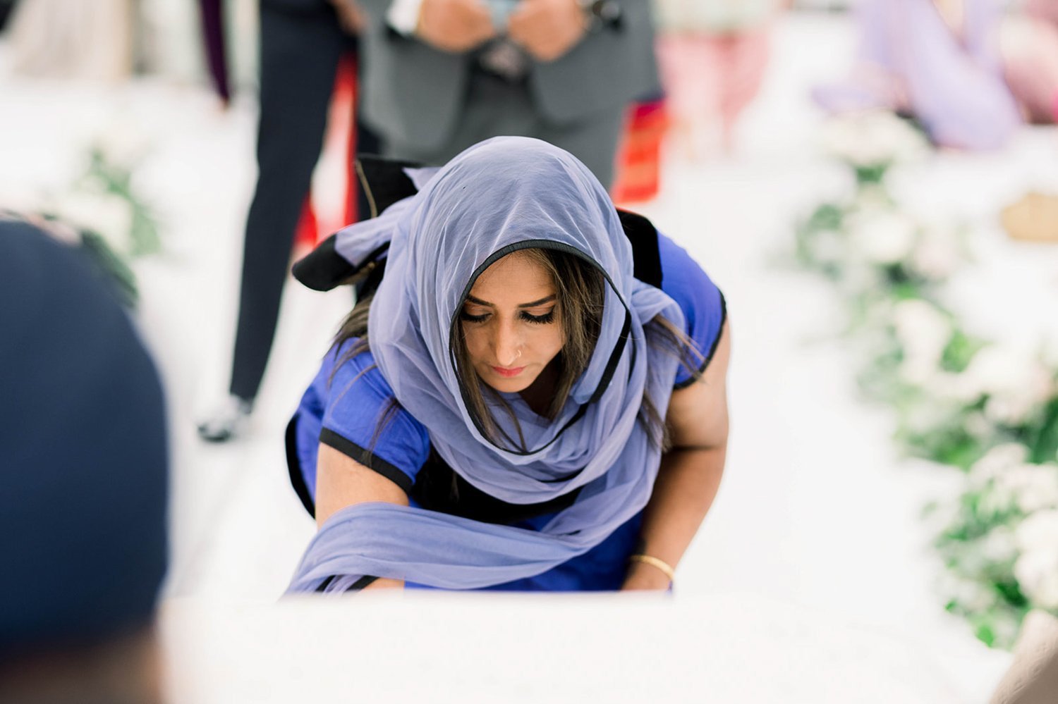 A woman gives and offering in temple before a wedding ceremony