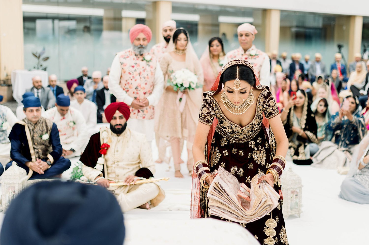 An indian bride makes an offering at the alter of a Sikh wedding in Victoria BC 