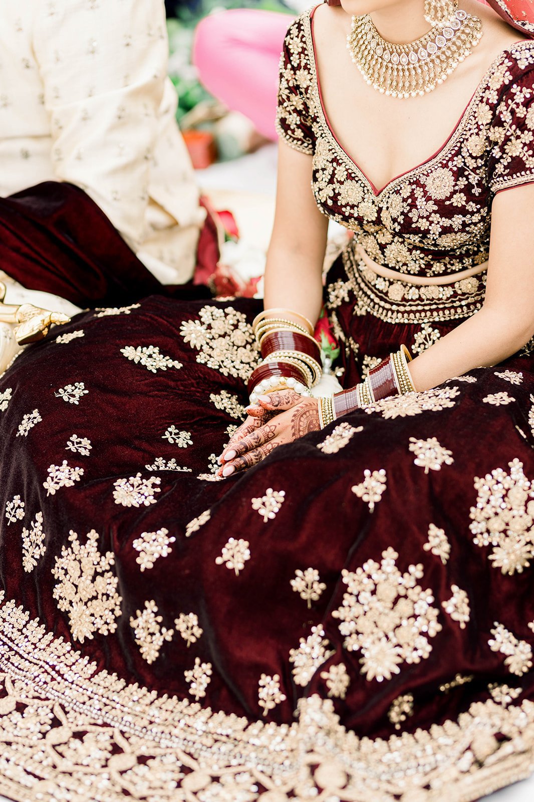 An indian bride clutches a red velvet pala in Victoria BC, photographed by Beautiful Life Studios