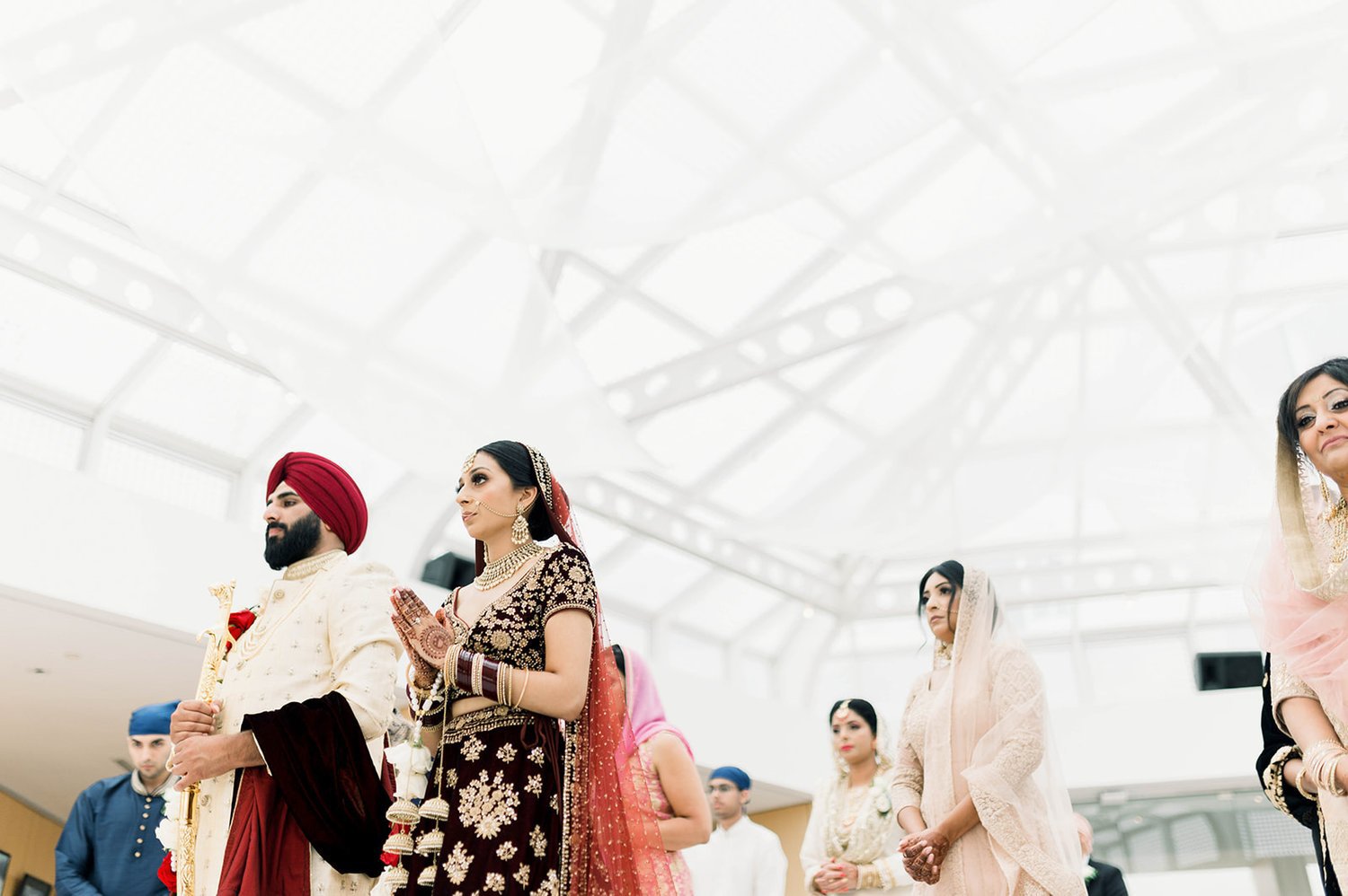 A south Asian couple prays during their Punjabi wedding in Victoria BC