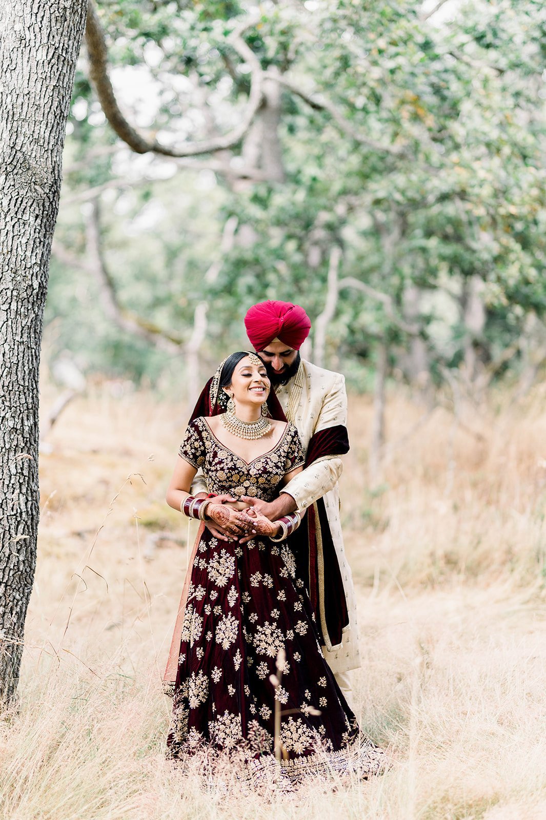 An south Asian couple cuddle during their photoshoot in Victoria BC