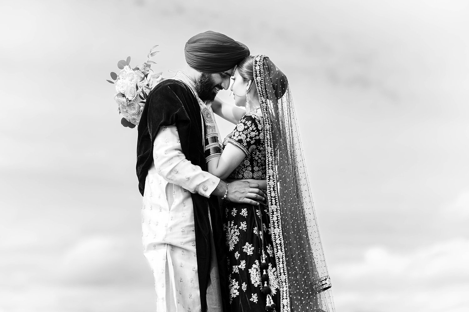 A south asian couple hug during their photoshoot in Victoria BC