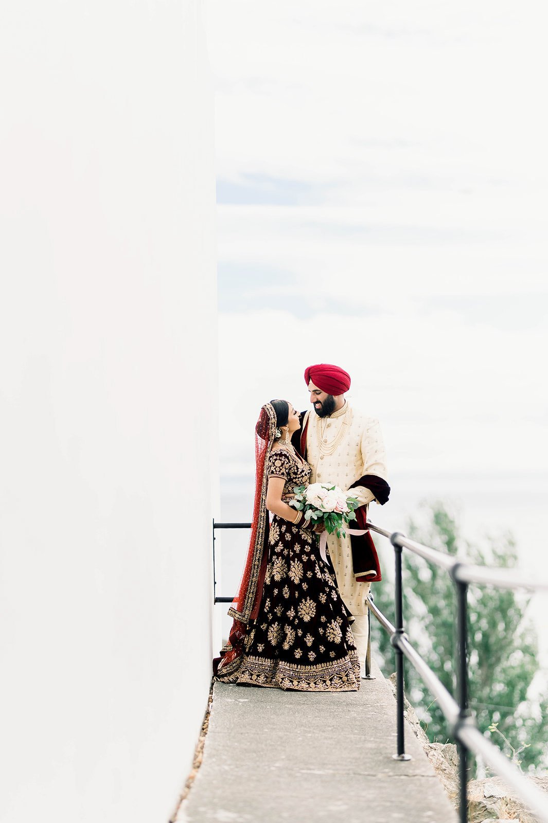 An indian bride and groom enjoy a moment as they look into each others eyes in Victoria BC