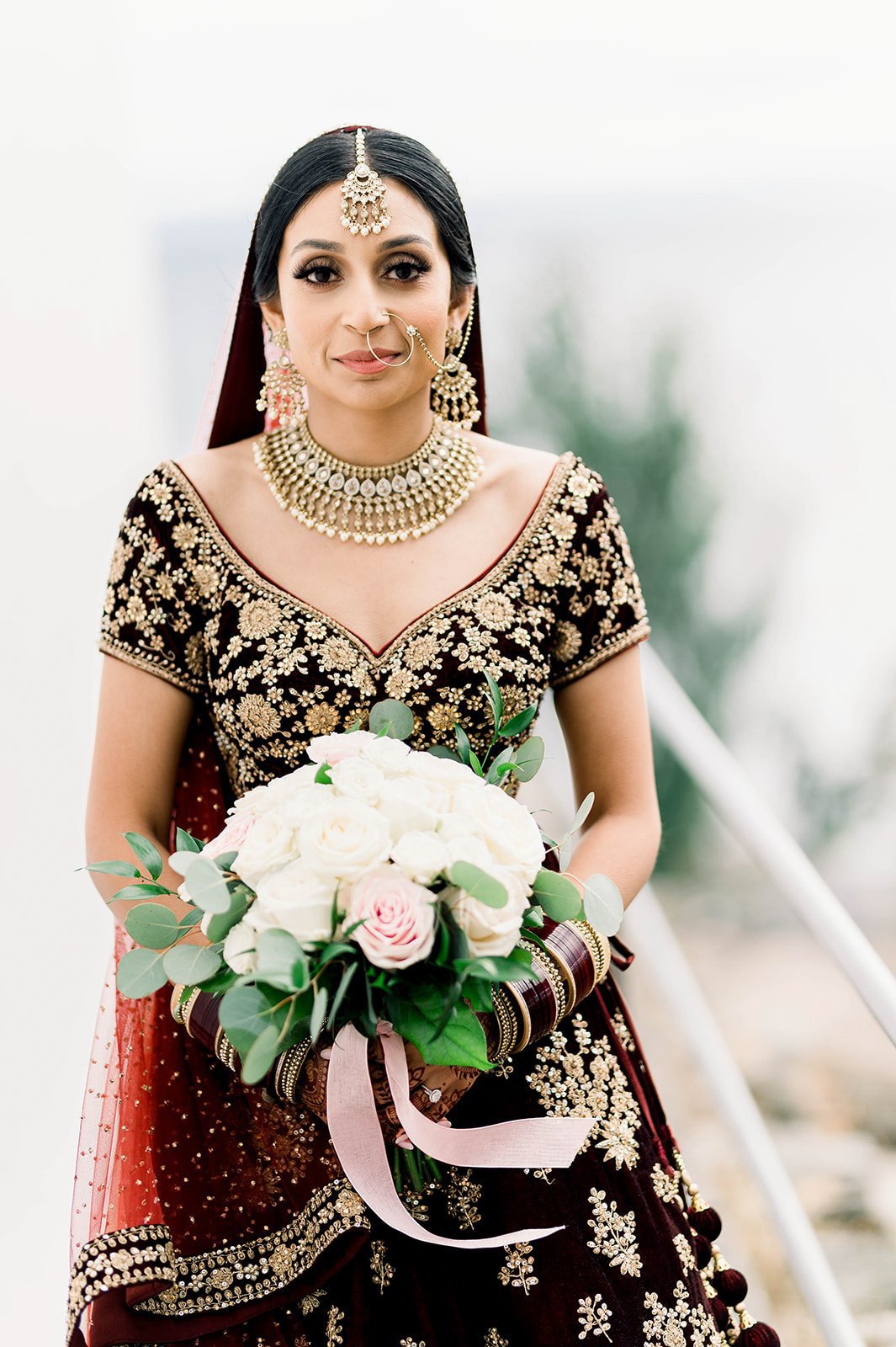A beautiful indian bride looks confidently into the camera during her photoshoot. 