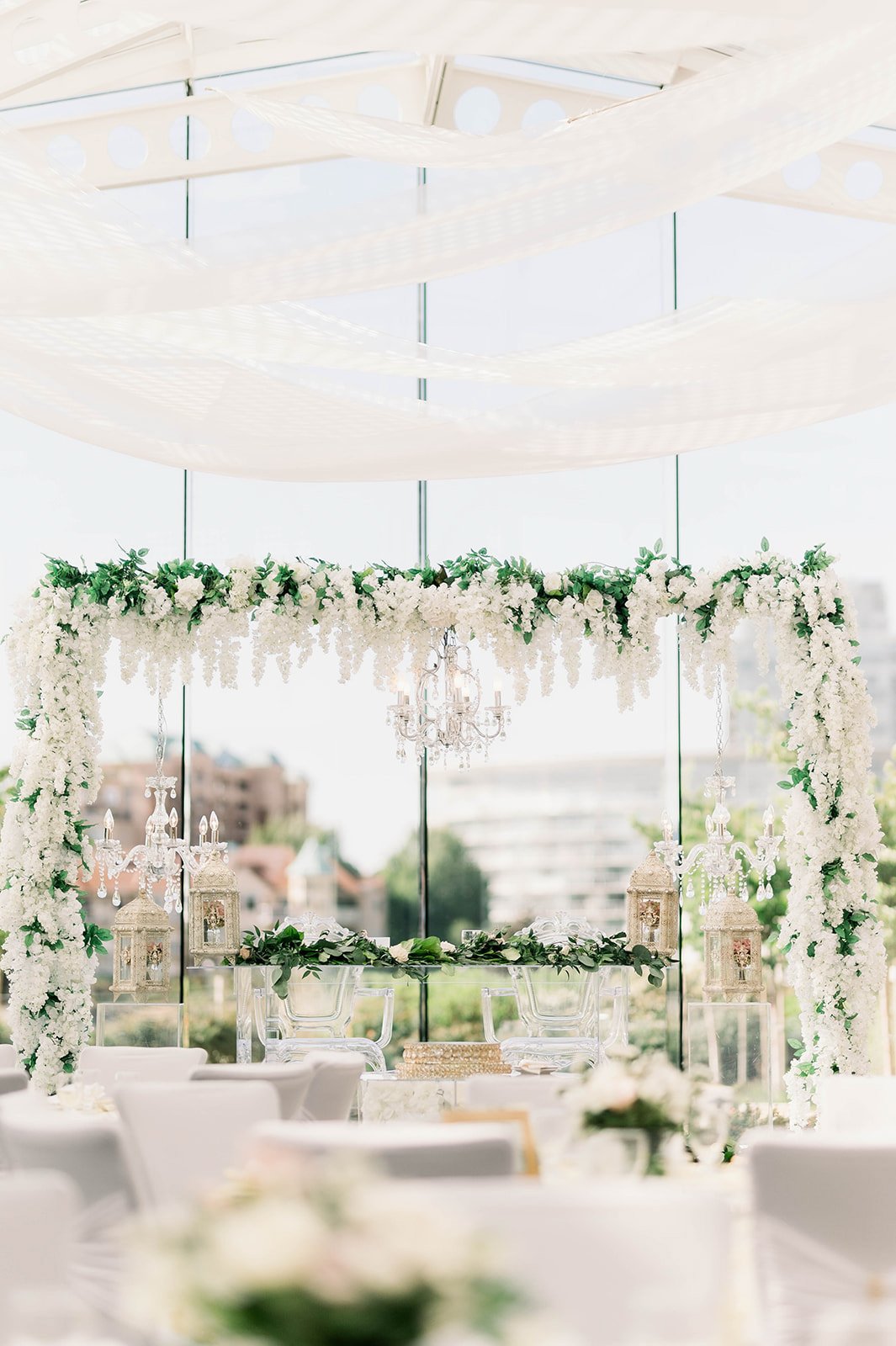Green and white floral elements adorn a beautiful white tent reception space in Victoria BC. 