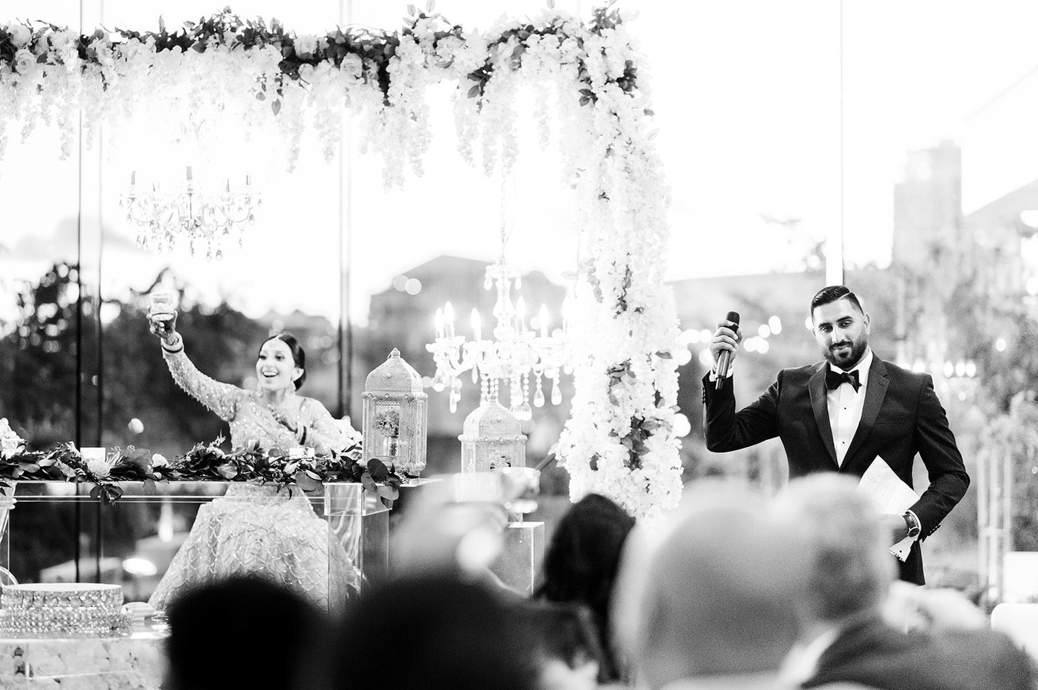 A groom raises a glass in a toast at his reception in Victoria BC 