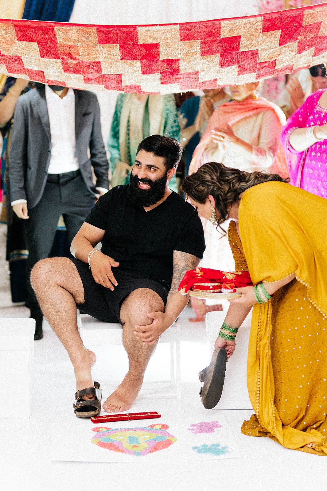 an indian groom takes off his shoes in preparation for his Mayian ceremony in Vancouver BC 