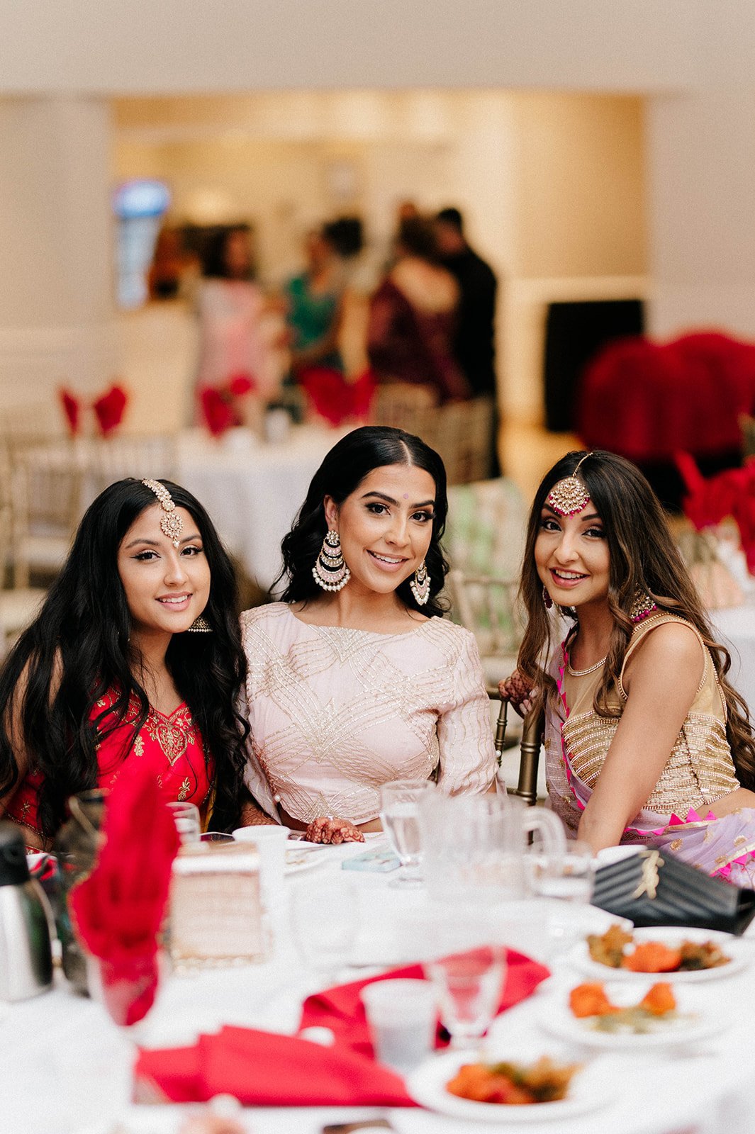 A bride smiles and poses with her friends during a mayian banquet in Surrey BC 