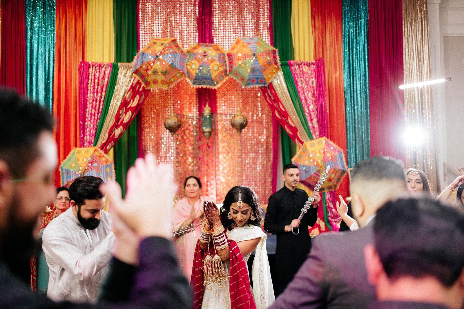 An indian bride dances on a crowded dancefloor during a jagoo party in surrey BC 