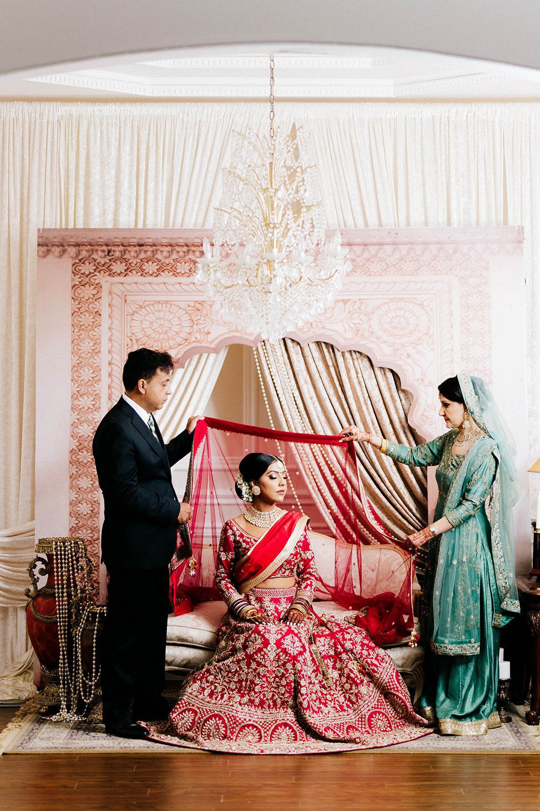 An indian bride's parents place a chunni on their daughters head in Surrey BC 