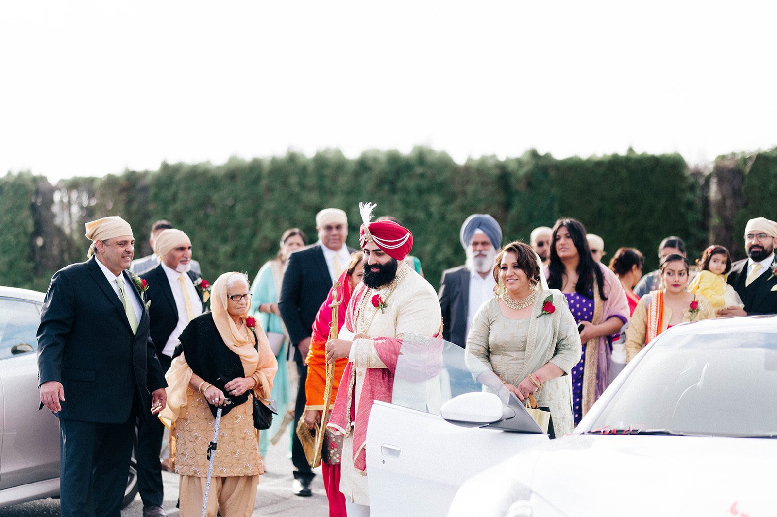 An indian groom leaves a car as he heads towards his wedding ceremony.