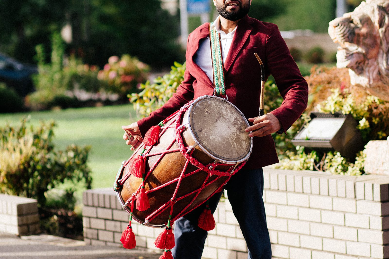 A dol player drums outside of an indian temple in surrey BC 