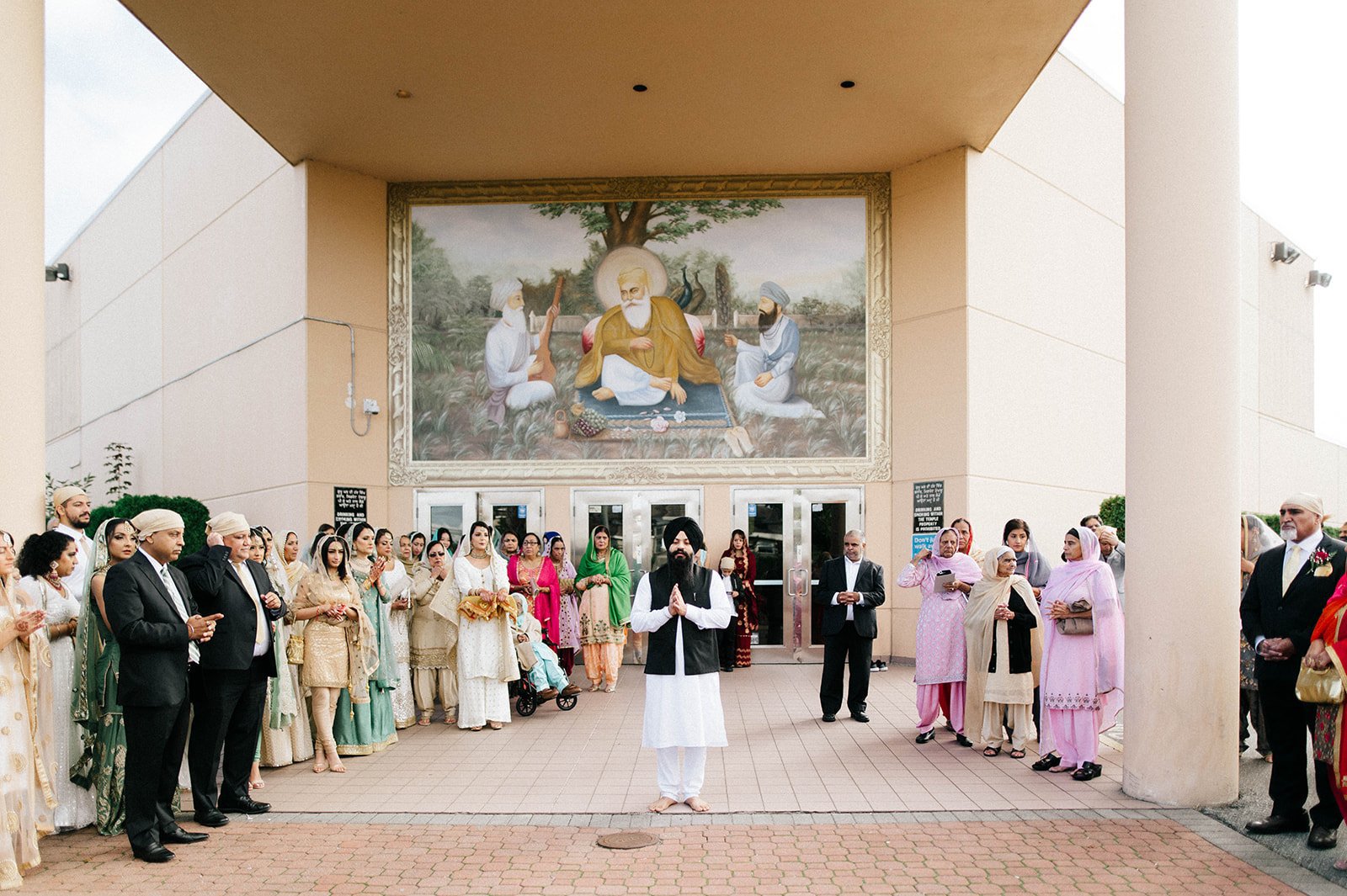 Two families pray outside a gurdwara before a wedding ceremony in Richmond, BC.