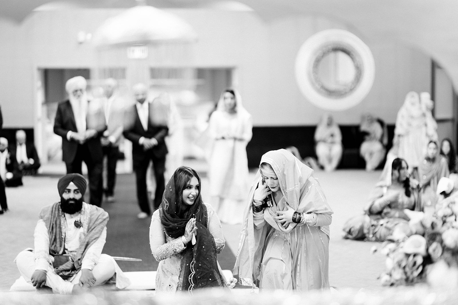 Two friends make an offering before a wedding ceremony