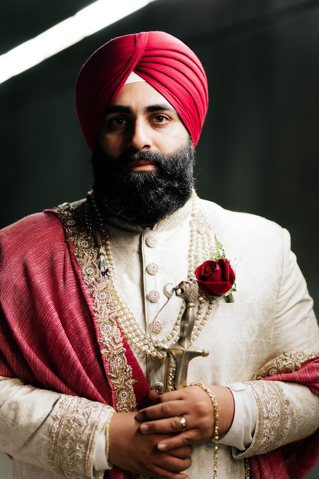An indian groom looks into the camera for a portrait in Vancouver BC 