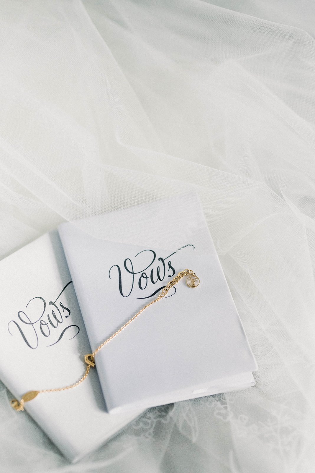 white and blue vow books lying on the bed. Beautiful Life Studios BC