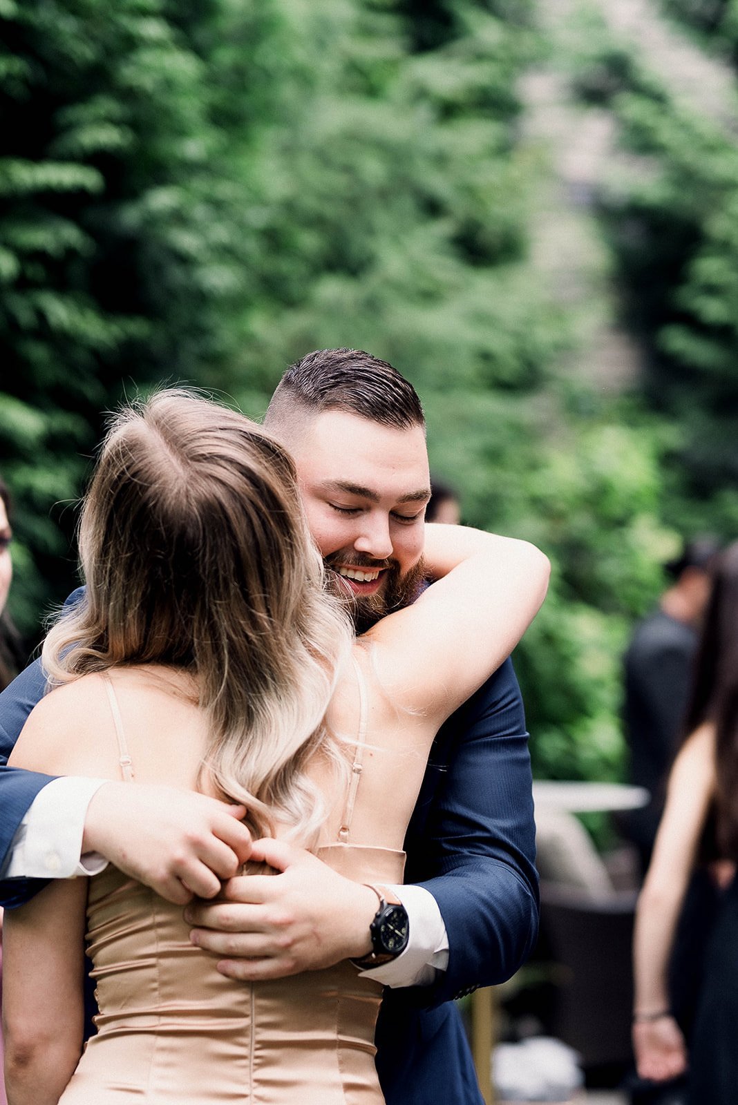 wedding guests hugging during a backyard ceremony in Vancouver, BC.