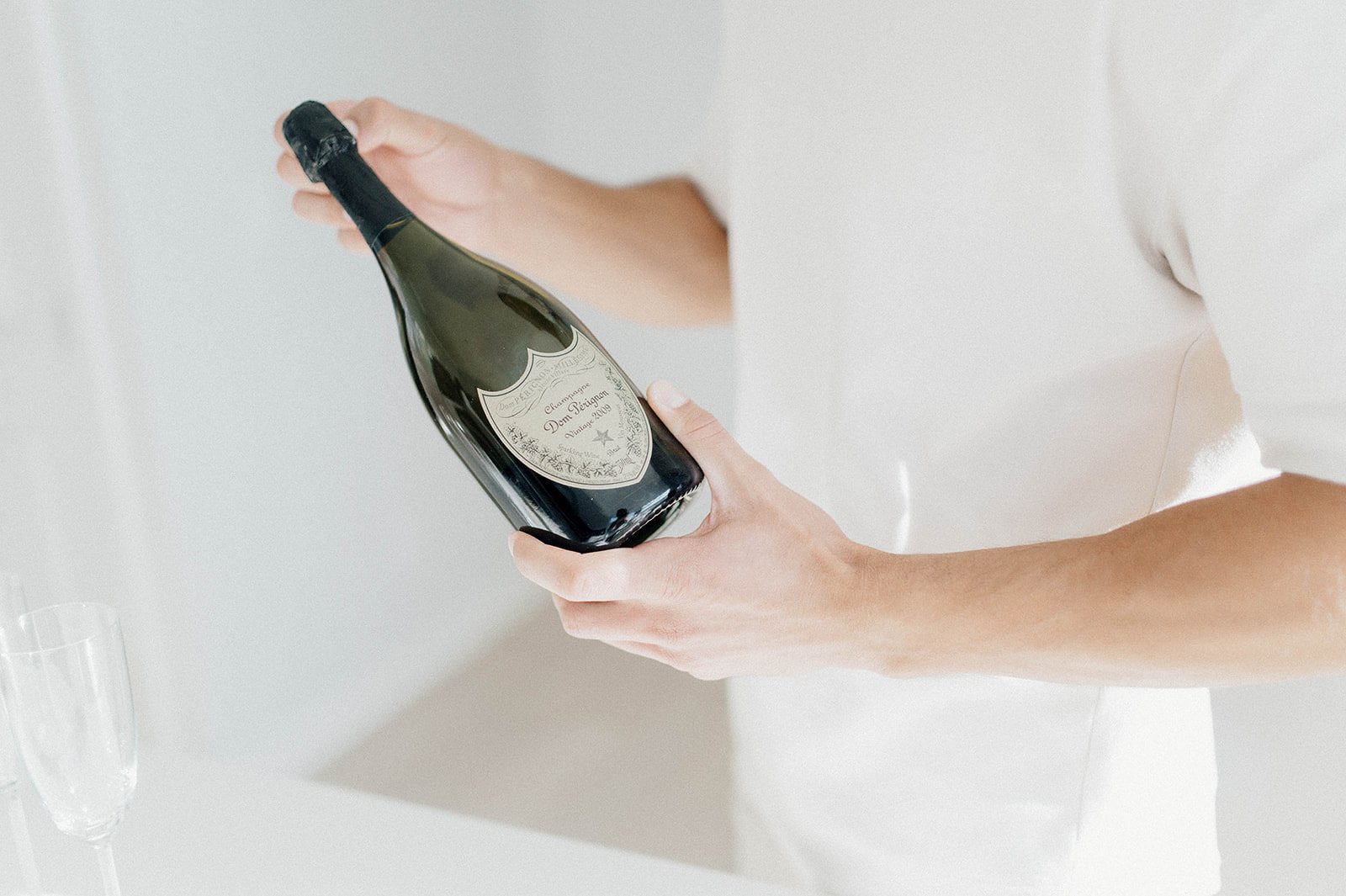 Man holding Don Perignon champagne during his engagement session with Beautiful Life Studios BC