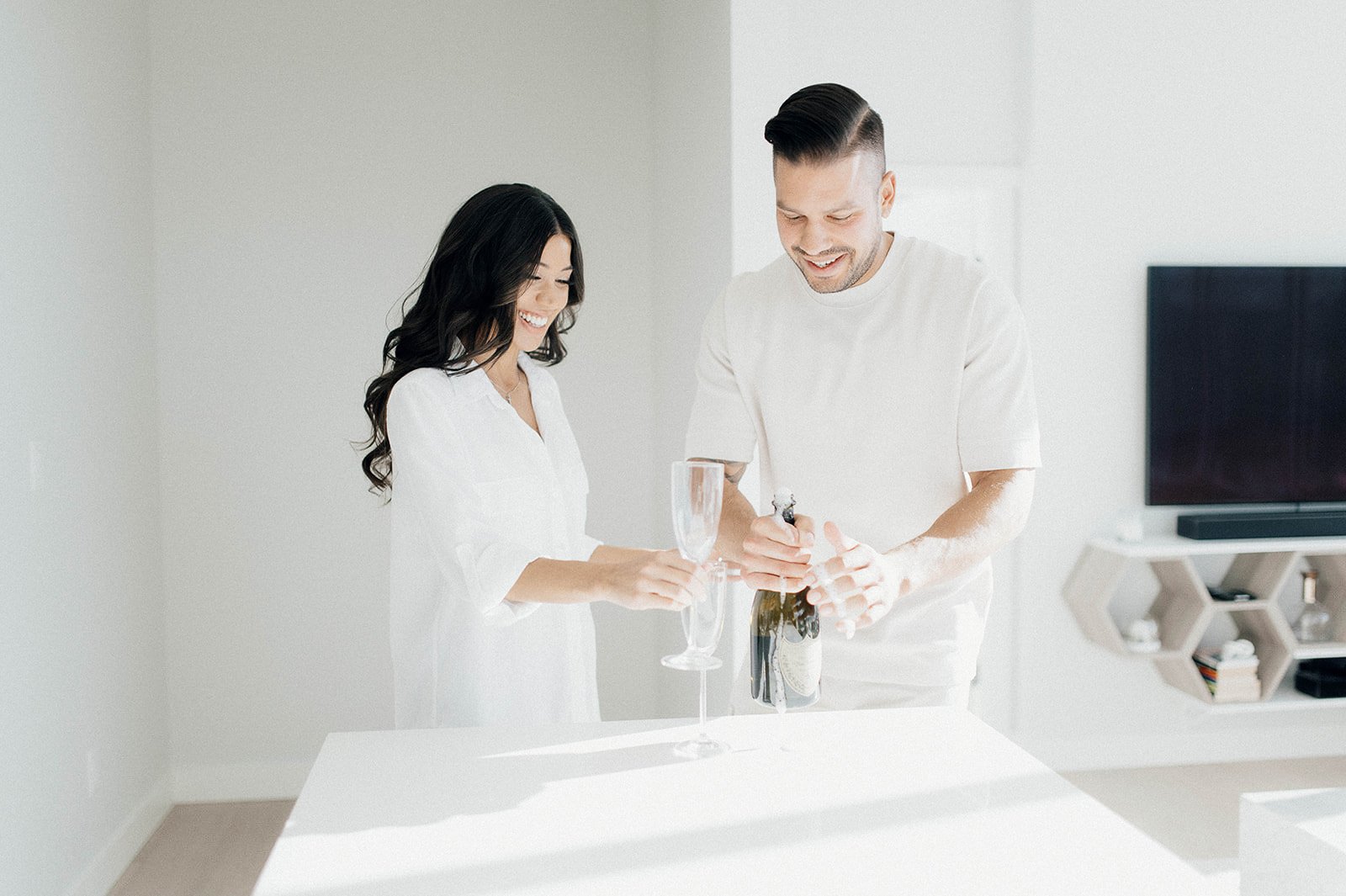 Couple opening Don Perignon champagne during their engagement session in Vancouver, BC.