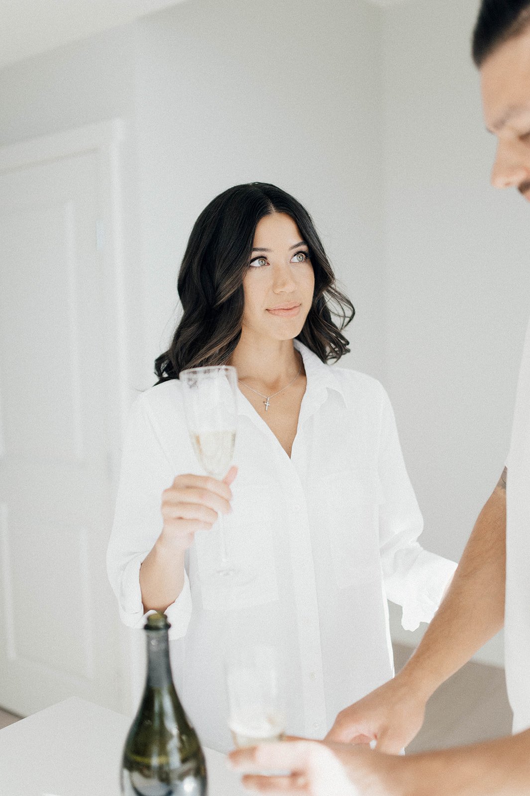 woman wearing white button up shirt during her engagement session in Vancouver, BC.