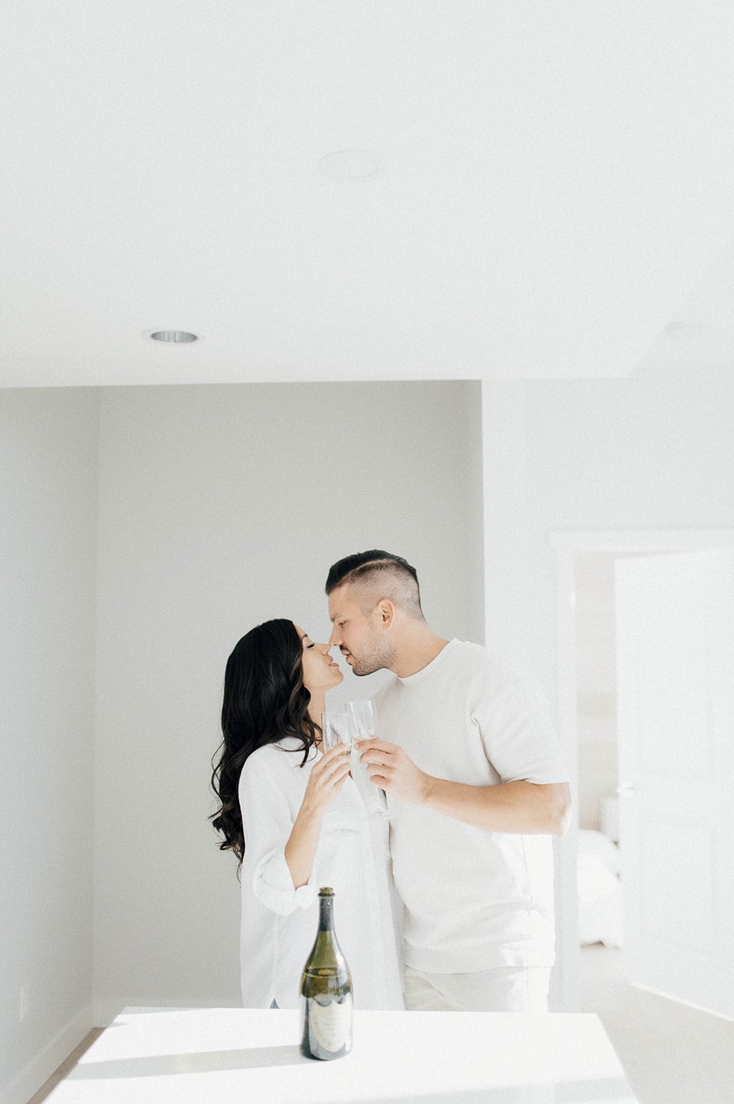 Couple kissing in their Vancouver, BC apartment during their engagement session with Beautiful Life Studios, BC.