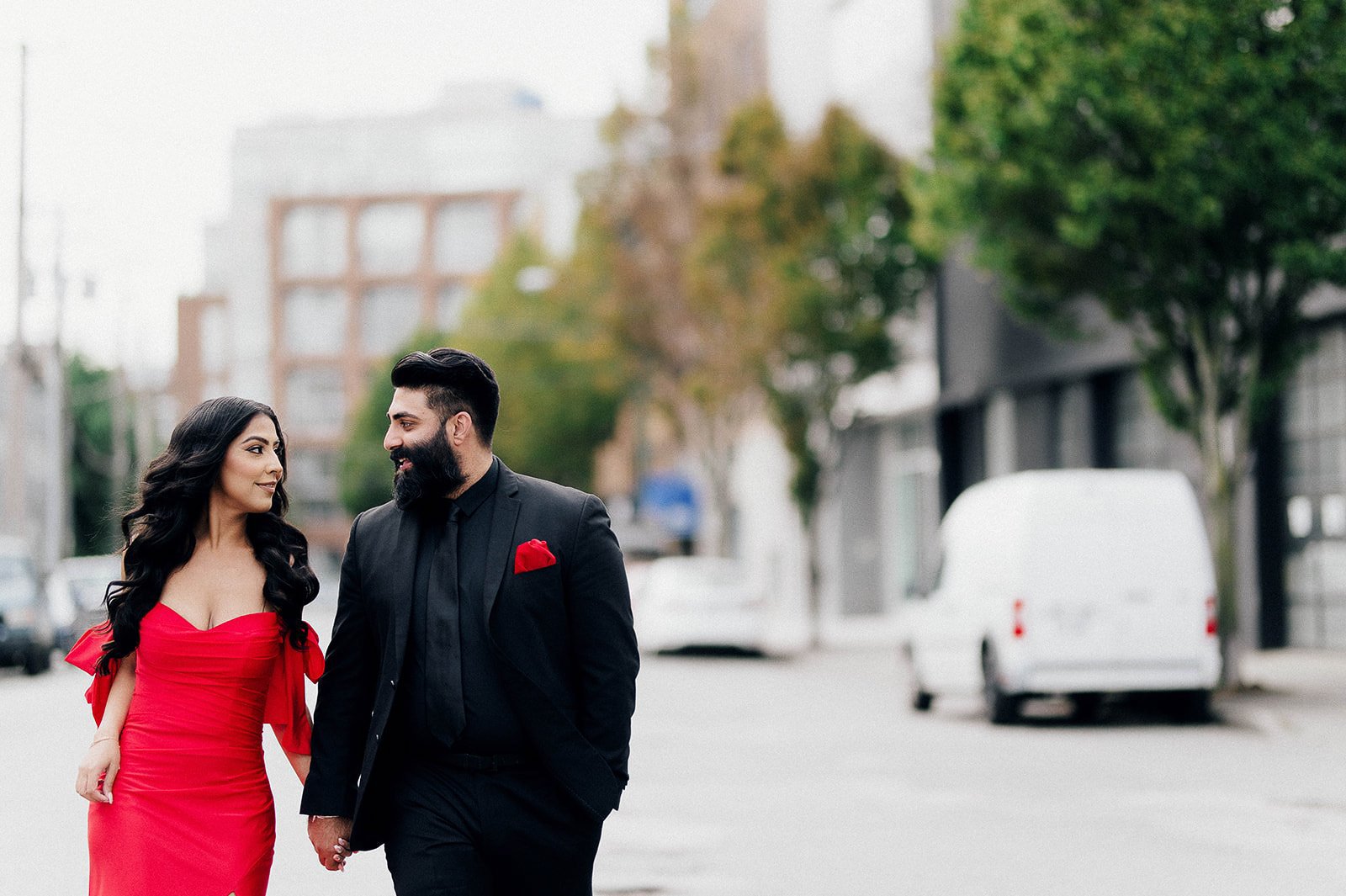 chic couple wearing red dress and black suite in Railtown Vancouver, BC. Beautiful Life Studios BC.