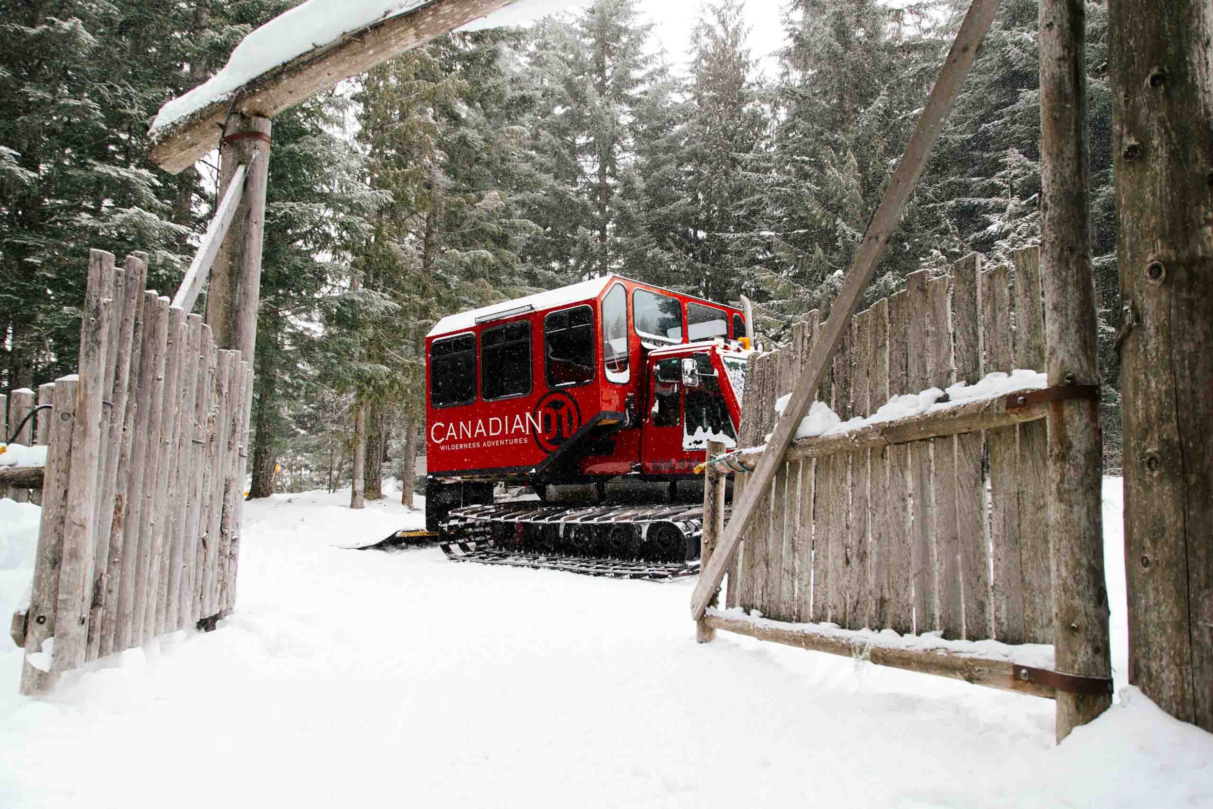 A red large snow mobile arrive in the snow in Whistler, BC. 