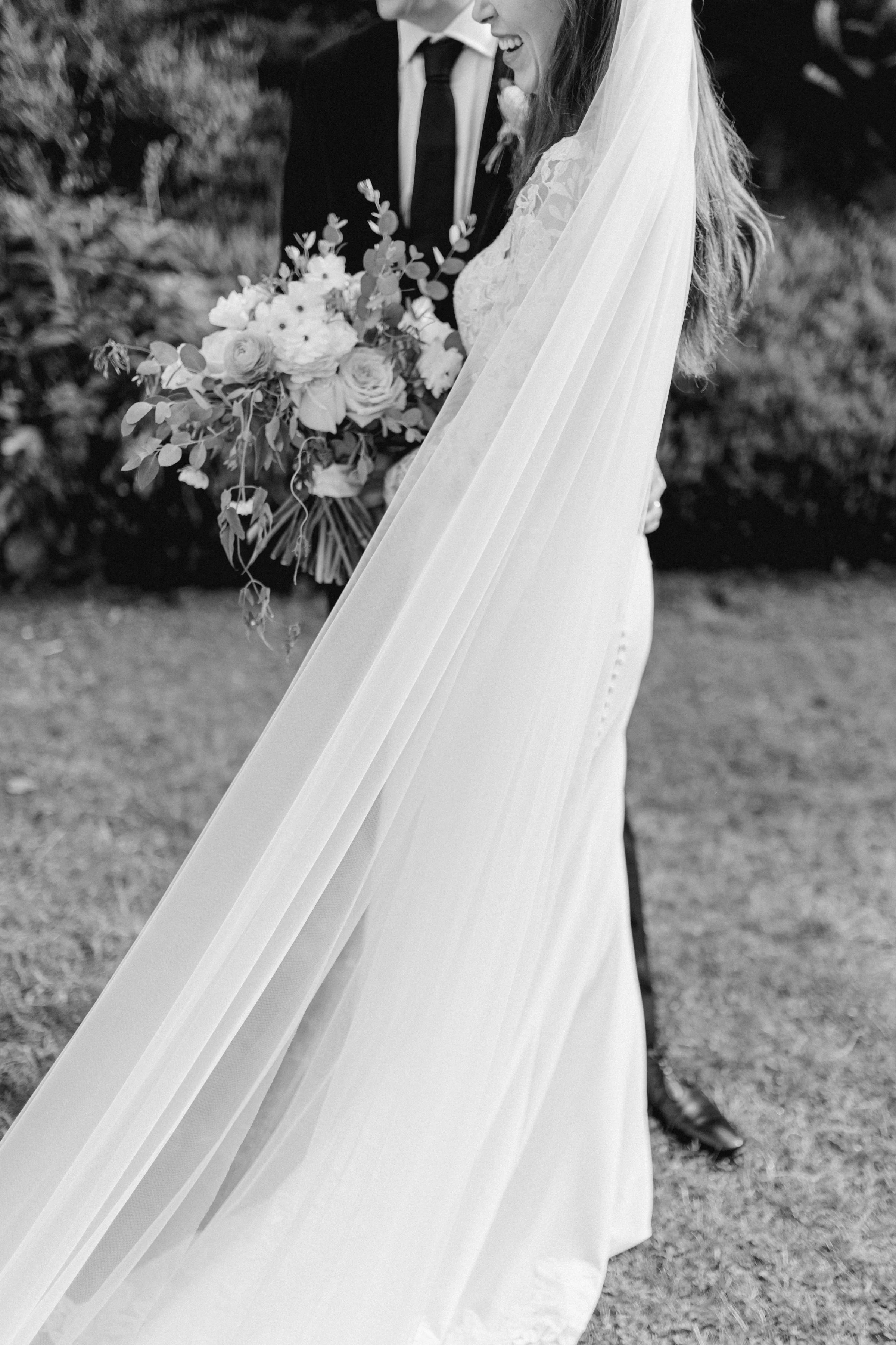 Bride holding a bouquet with flowing veil at Cecil Green Park House.
