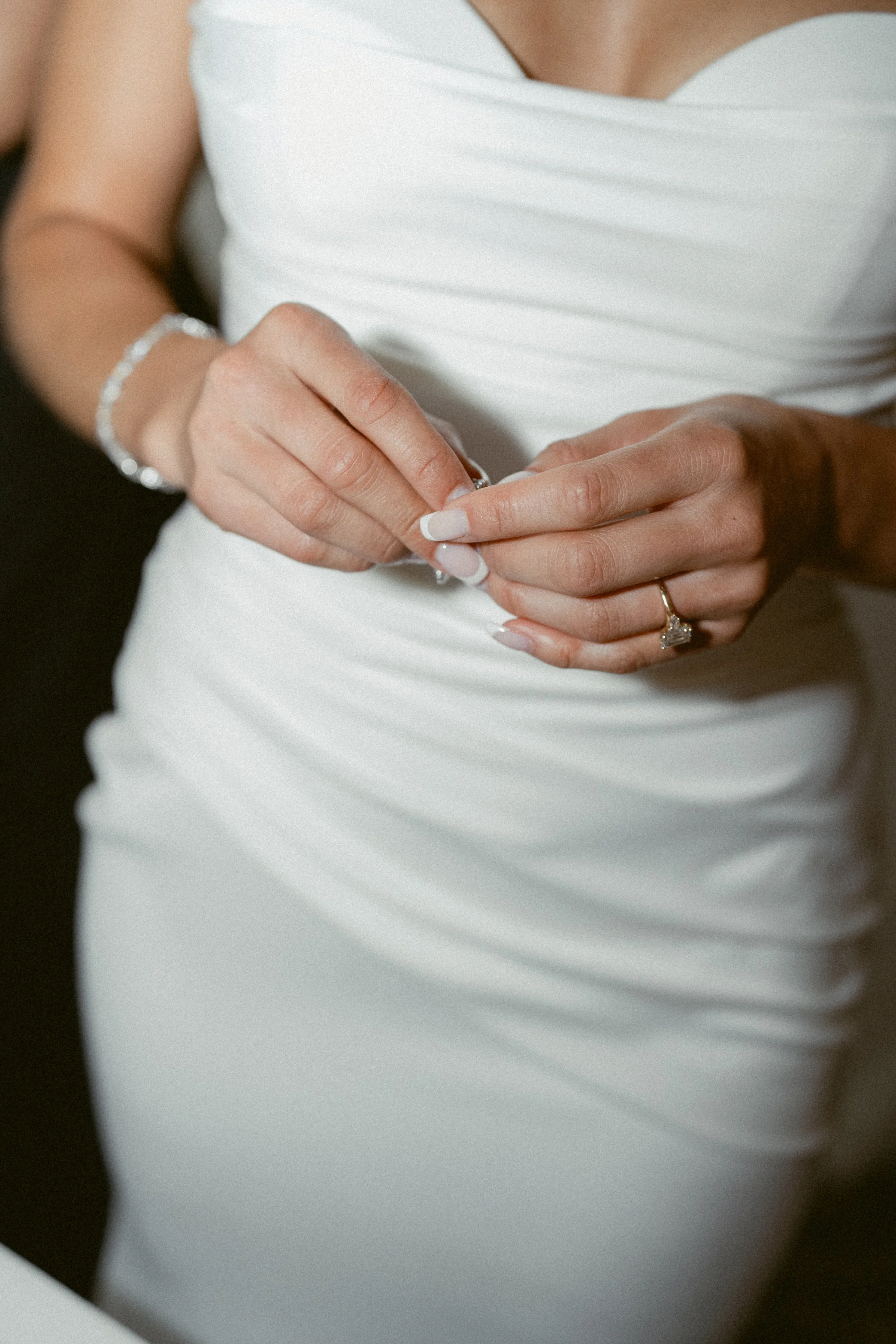 Bride adjusting her veil during bridal portraits at the Vancouver Club.