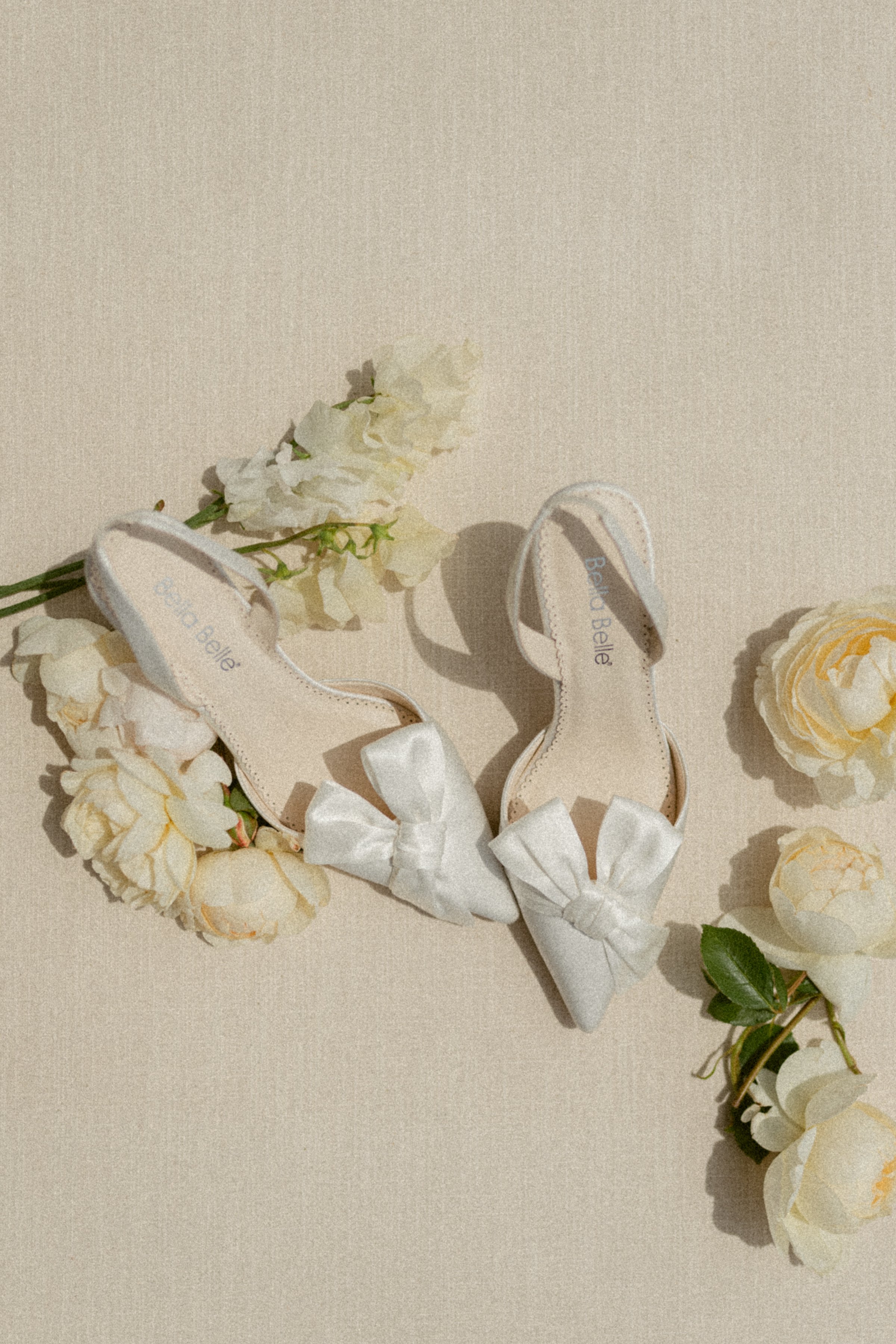 Wedding day flatlay with flowers and shoes.