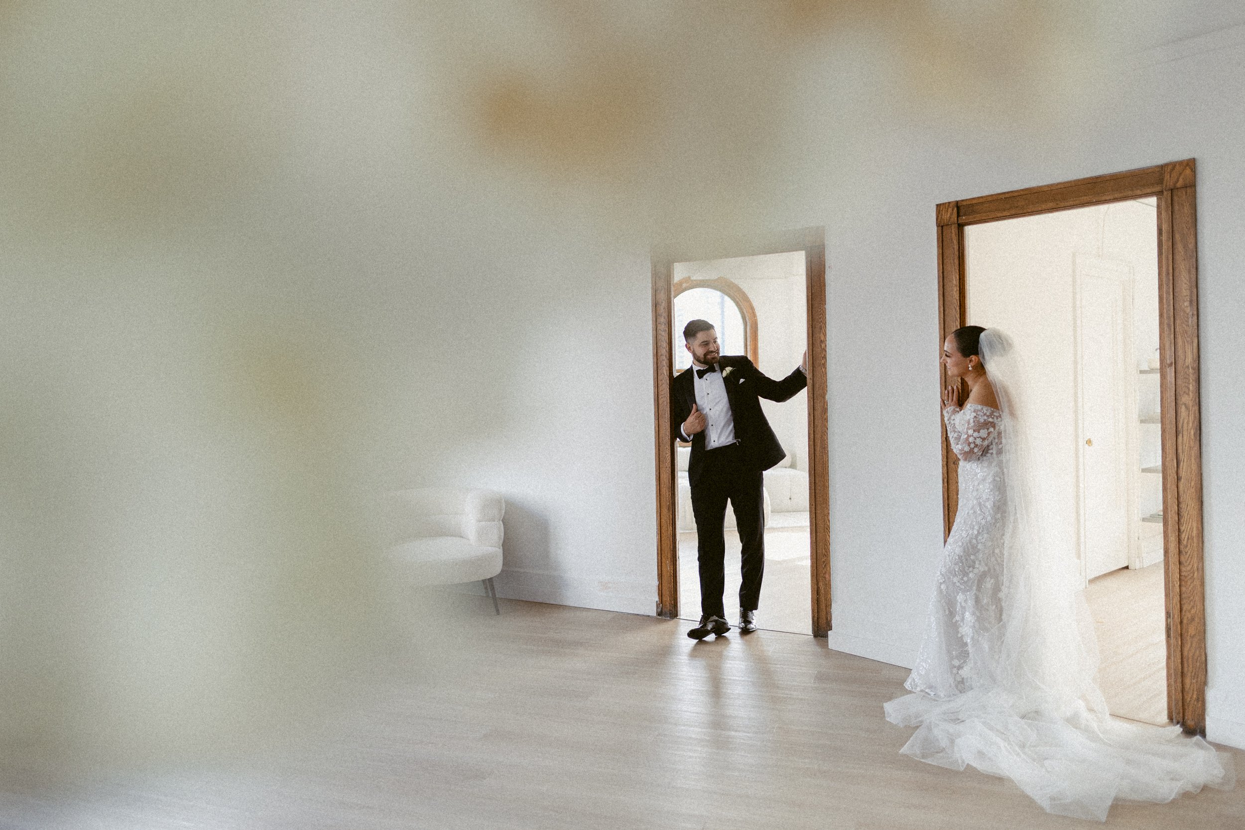 Bride and groom sharing a first look inside a bright room.