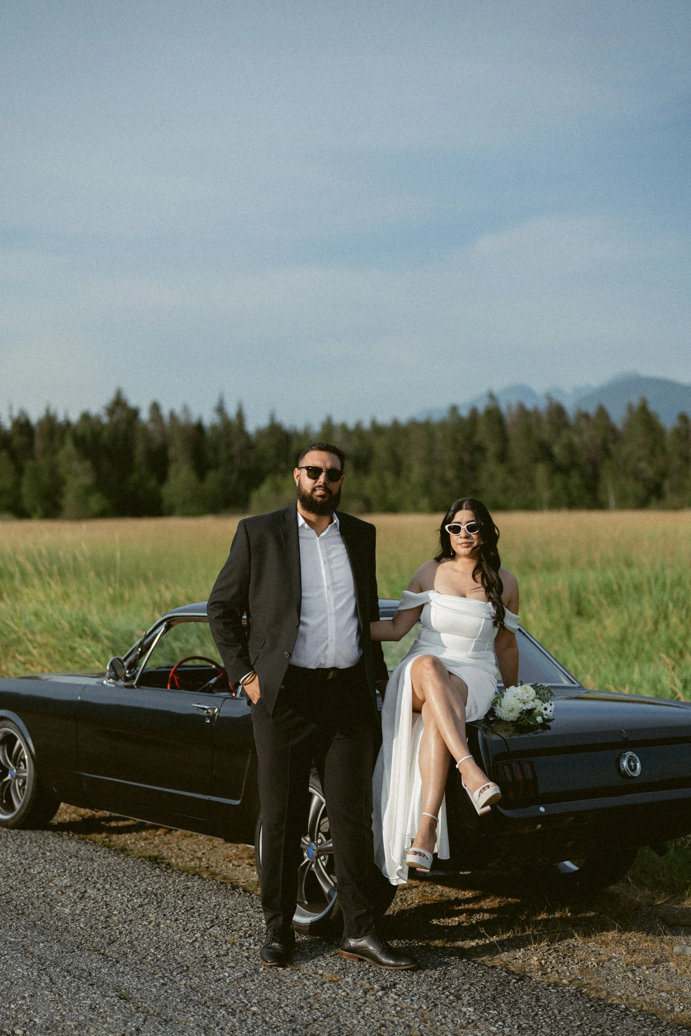 Engaged couple posing with a vintage car during a Pitt Lake session.