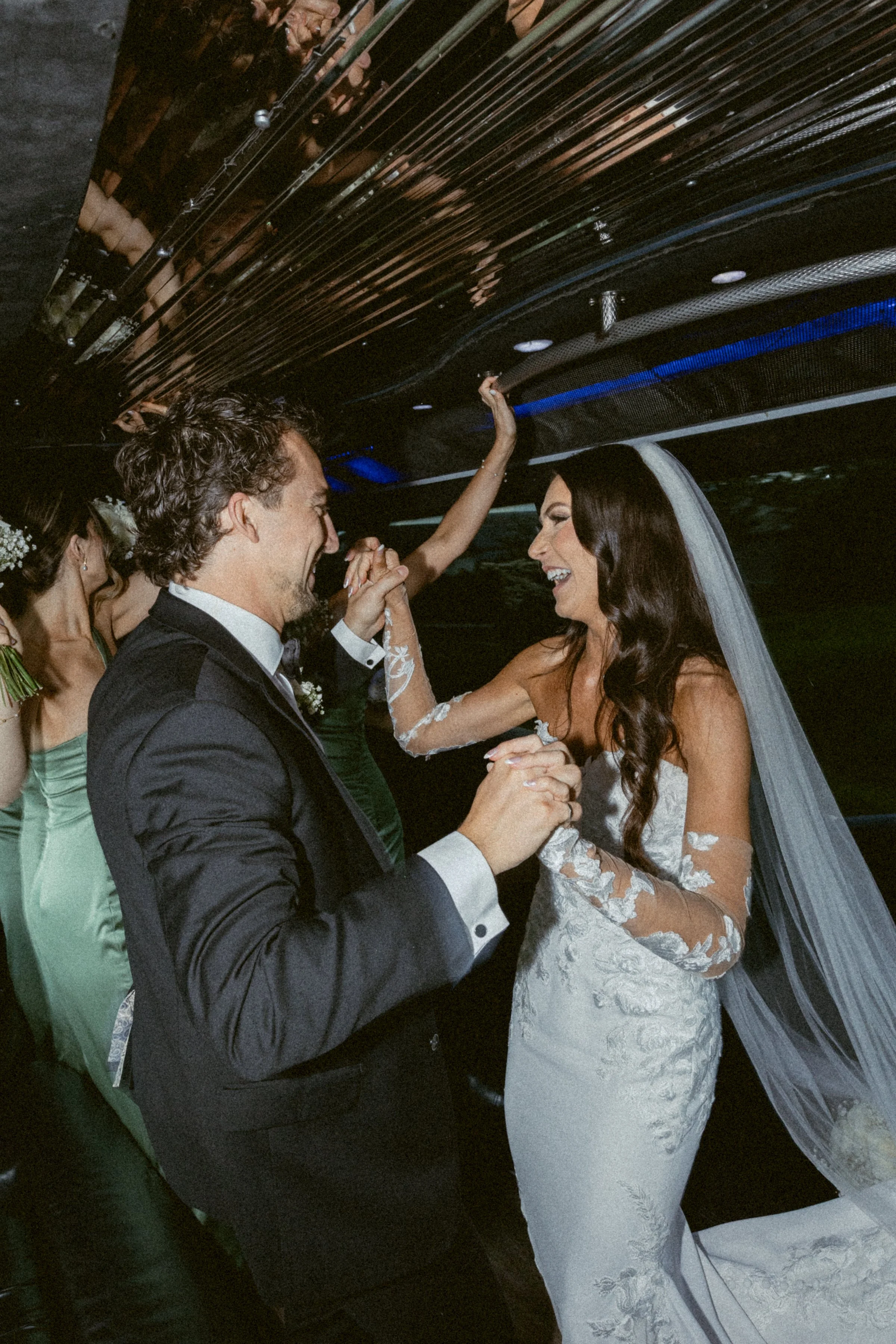 Bride and groom dancing together in the limo.