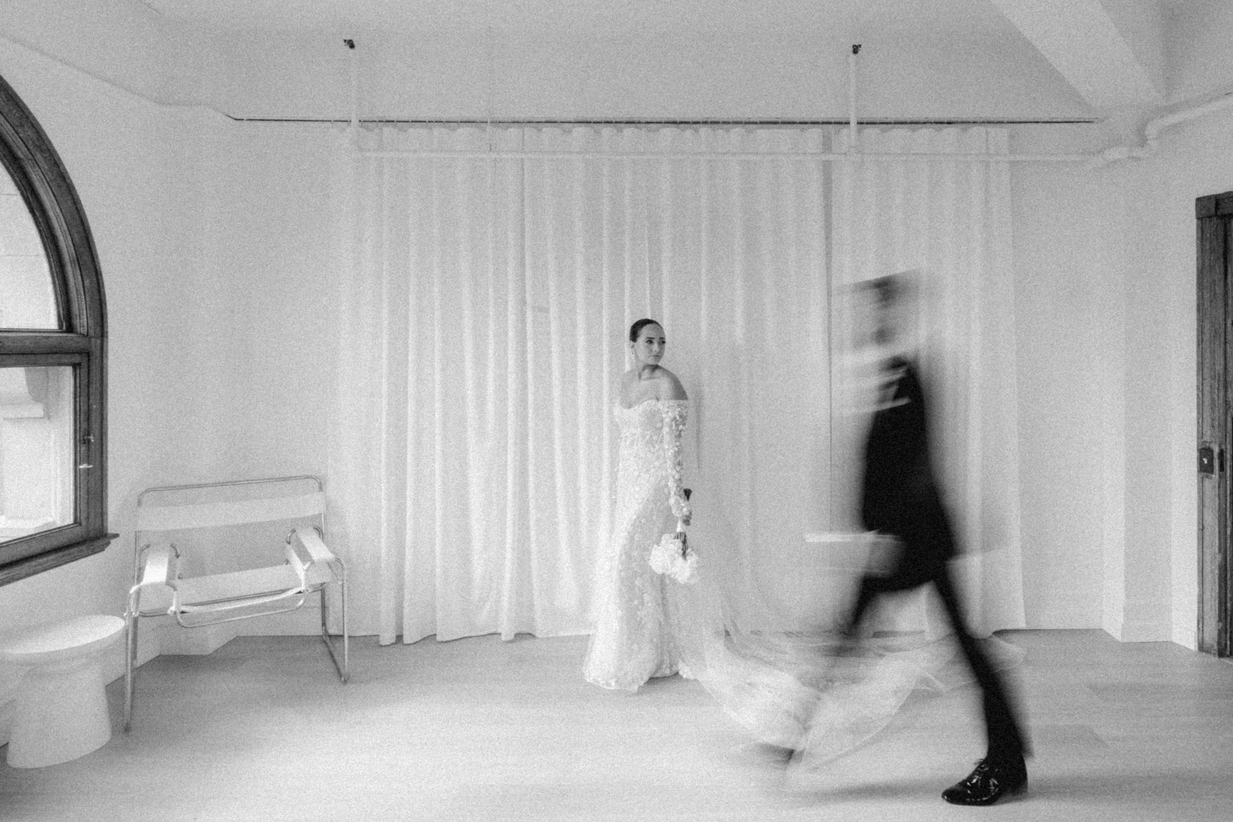Artistic black and white wedding portrait with motion blur.
