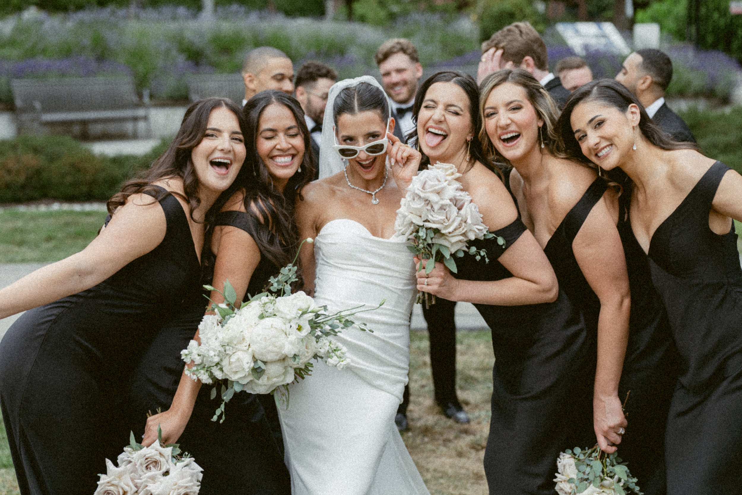 Bride laughing with bridesmaids during portraits at Shannon Mews.