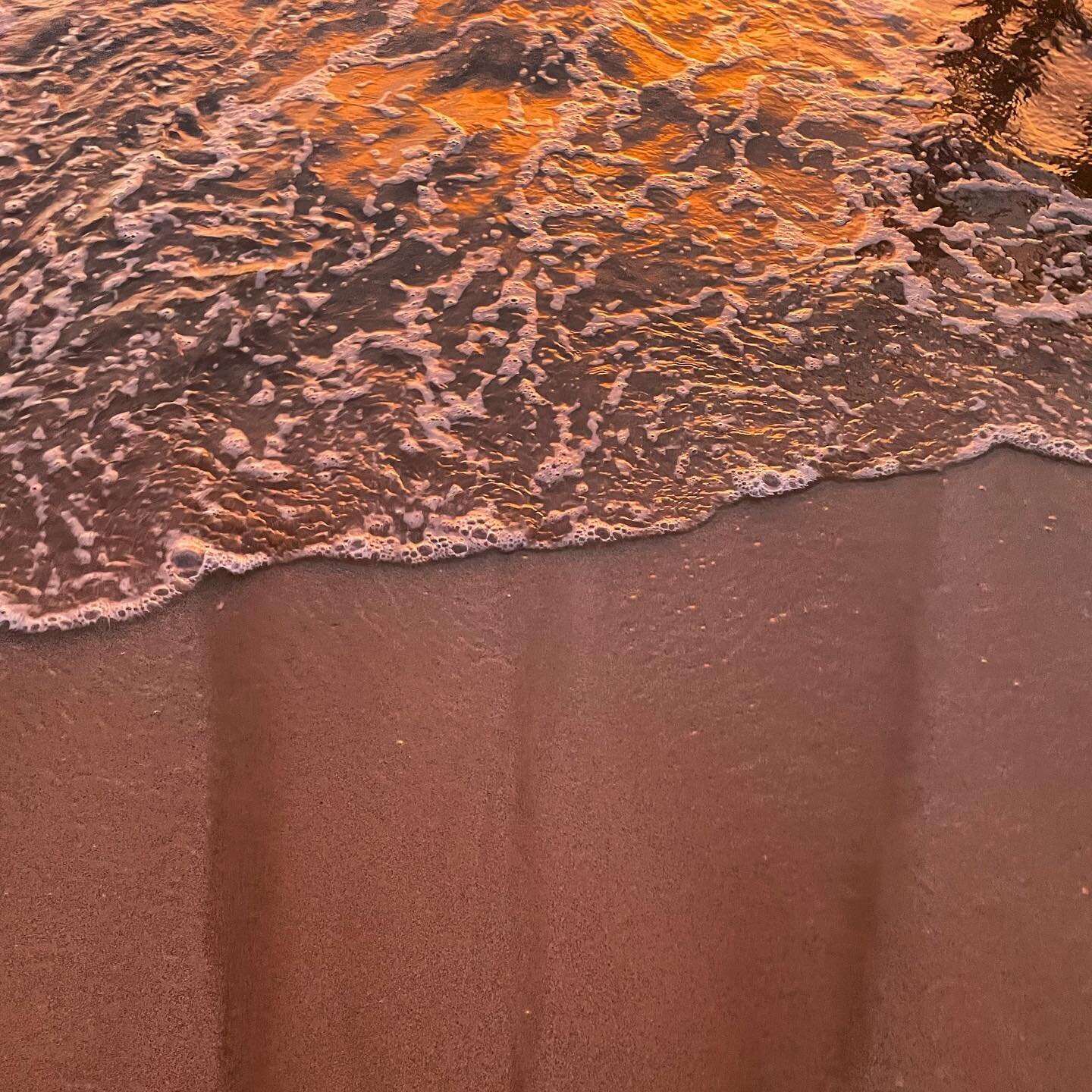 Water and sand at sunset