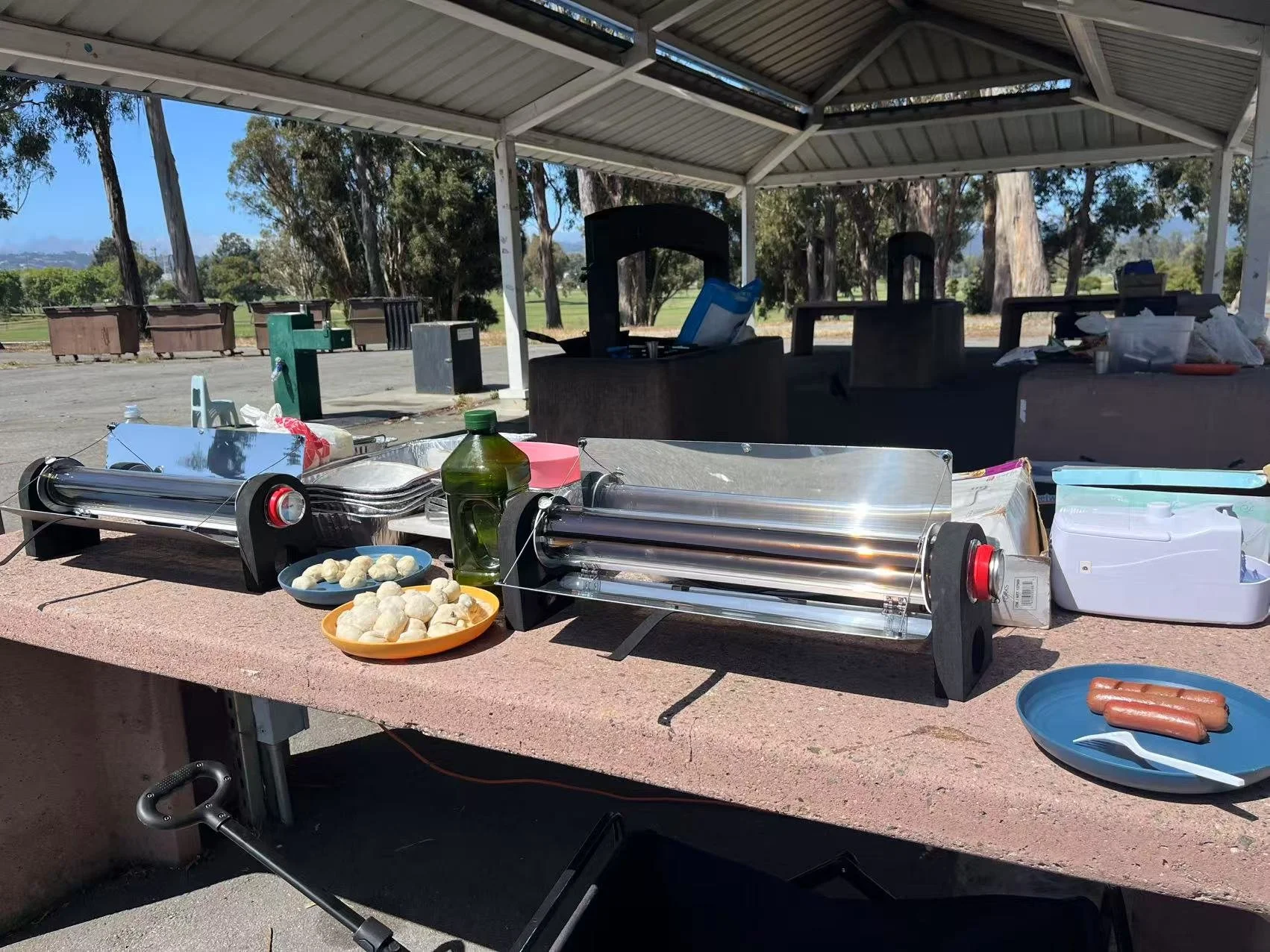  Camp setup of tubular solar cookers with sauseges and dumplings for campers. 