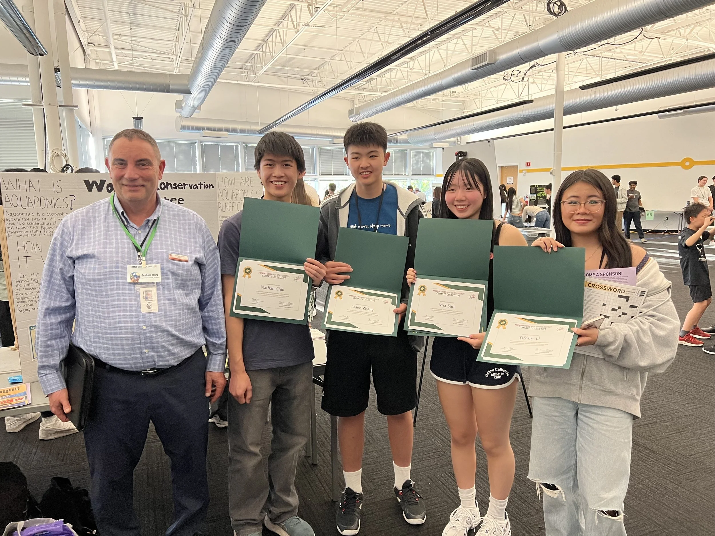  Nathan Chiu (Mountain View High School), Aiden Zhang (Basis Independent Silicon Valley), Mia Sun (Fremont High School), Tiffany Li (Pinewood School) earned outstanding environmental stewardship and contribution to the FUHSD Earth Day 2025 award from FUHSD Superintendent Mr. Graham Clark. 