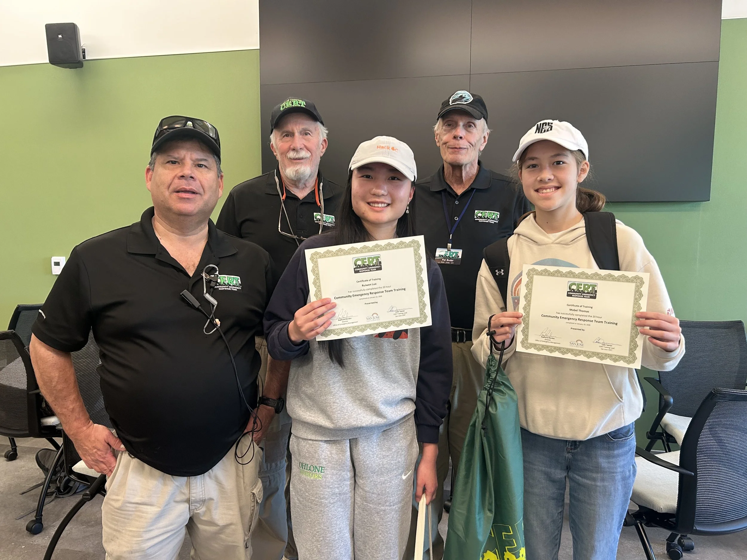  Two members taking pictures with the CERT instructors. 