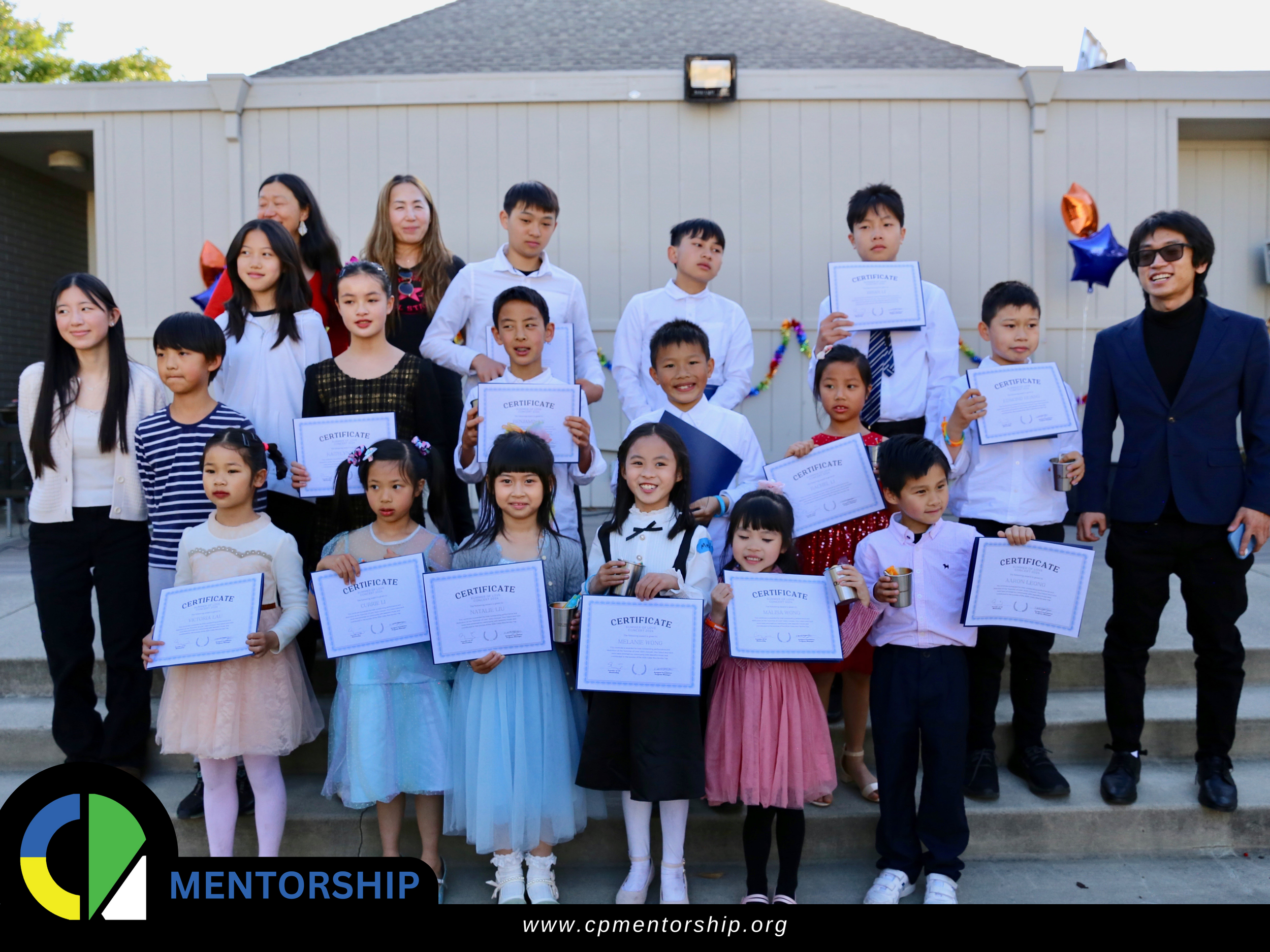 A group of children and adults posing outdoors with certificates. The children are dressed in formal attire. The bottom of the image has the logo and website URL of CPMentorship.