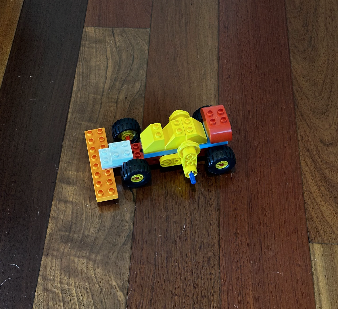 Lego toy car on wooden floor