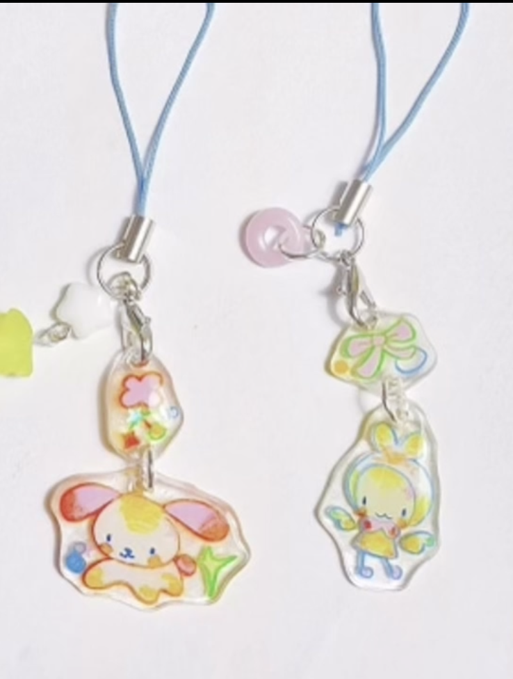 Two colorful character keychain charms with blue cords