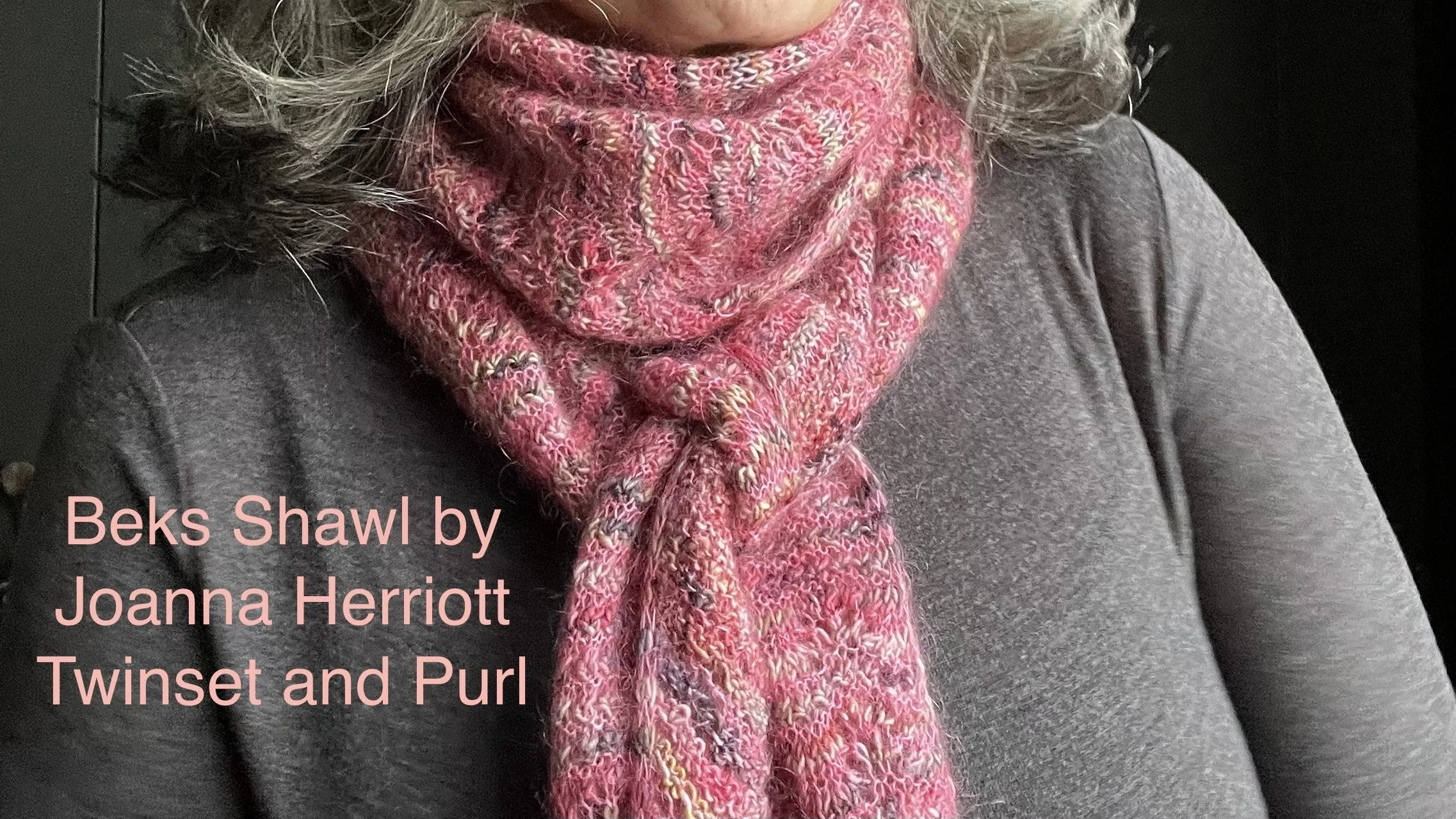 Women with silver hair wearing the new Beks Shawlette/scarf designed by Joanna Herriott of Twinset and Purl