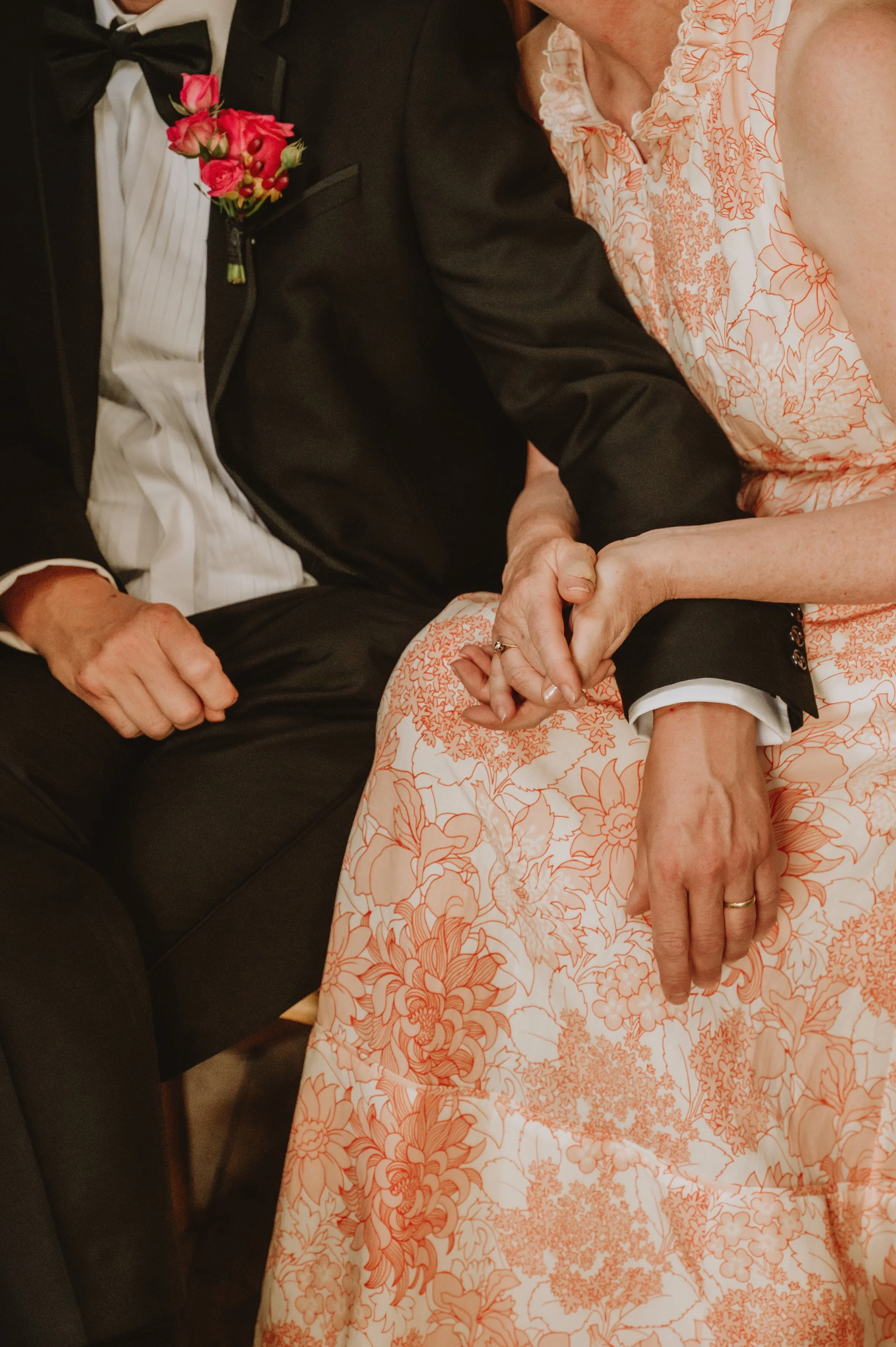 Father and mother of a bride hold hands at Middleton lodge during the ceremony, captured by Jules Williams Photography