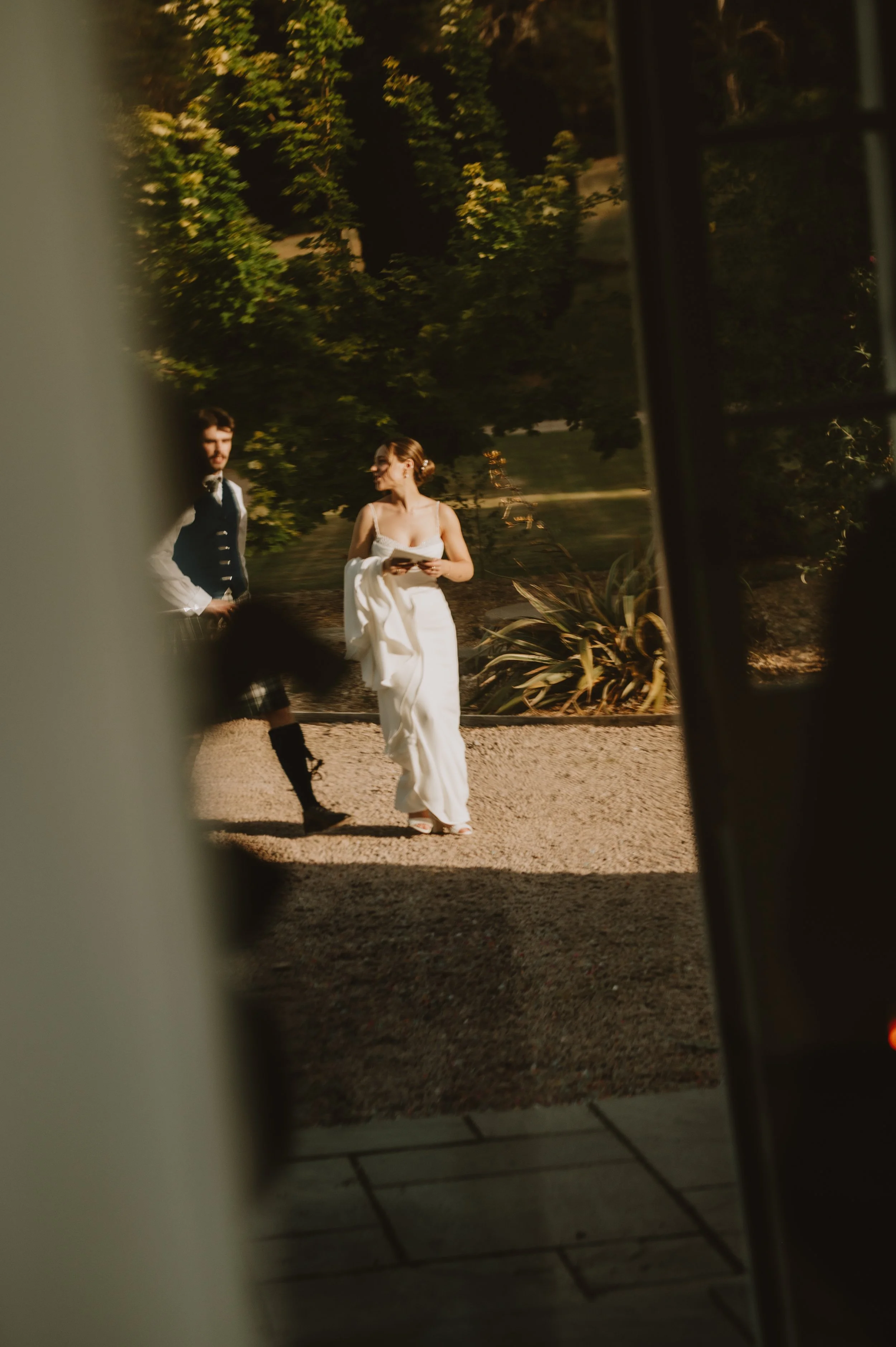 Reflection of bride and groom on their wedding day, captured by Jules Williams Photography