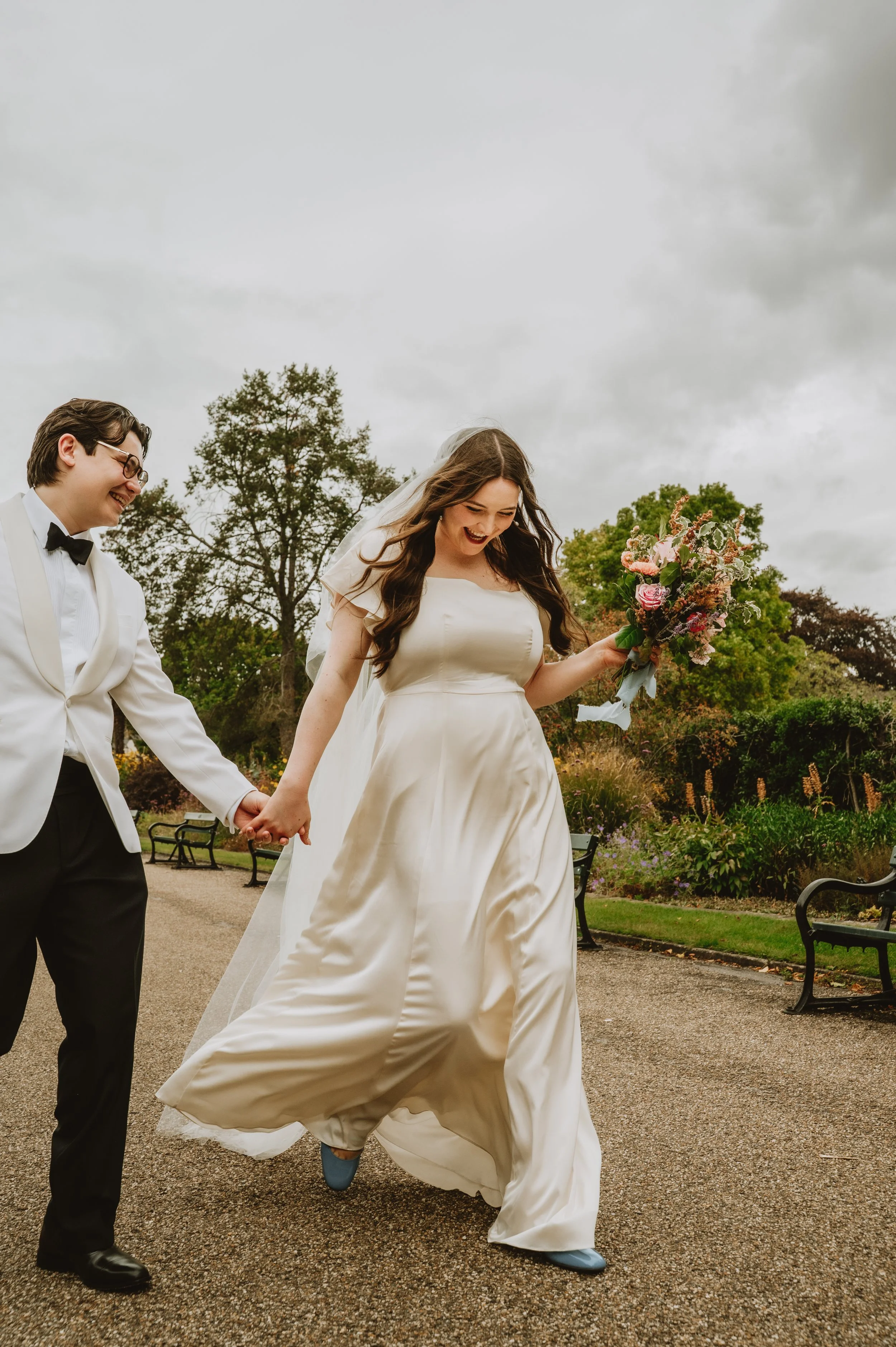 Bride and groom laughing together on their wedding day atSheffield Botanical Garden, captured by Jules Williams Photography