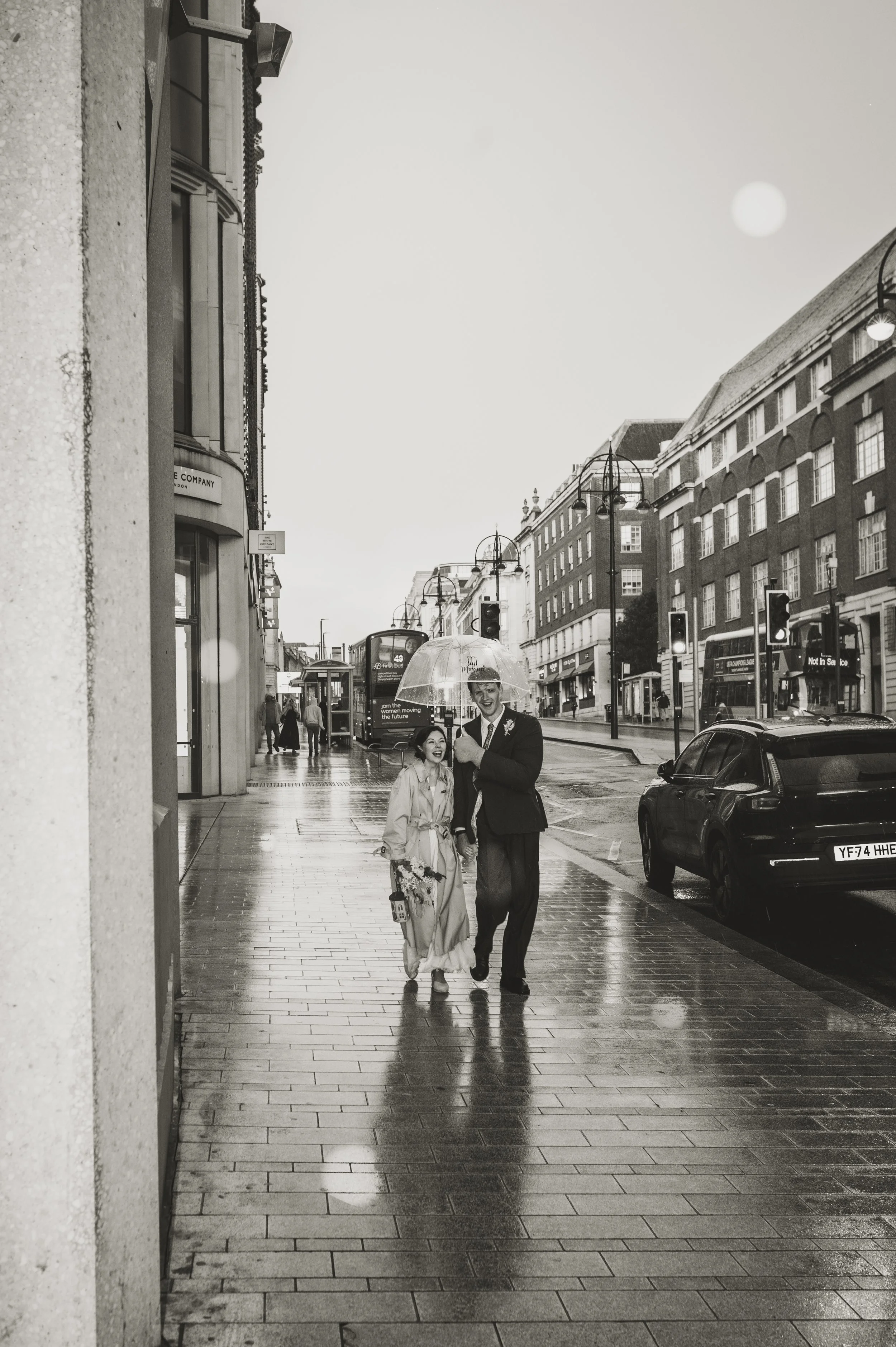 Bride and groom in the rain on their wedding day in Leeds, captured by Jules Williams Photography