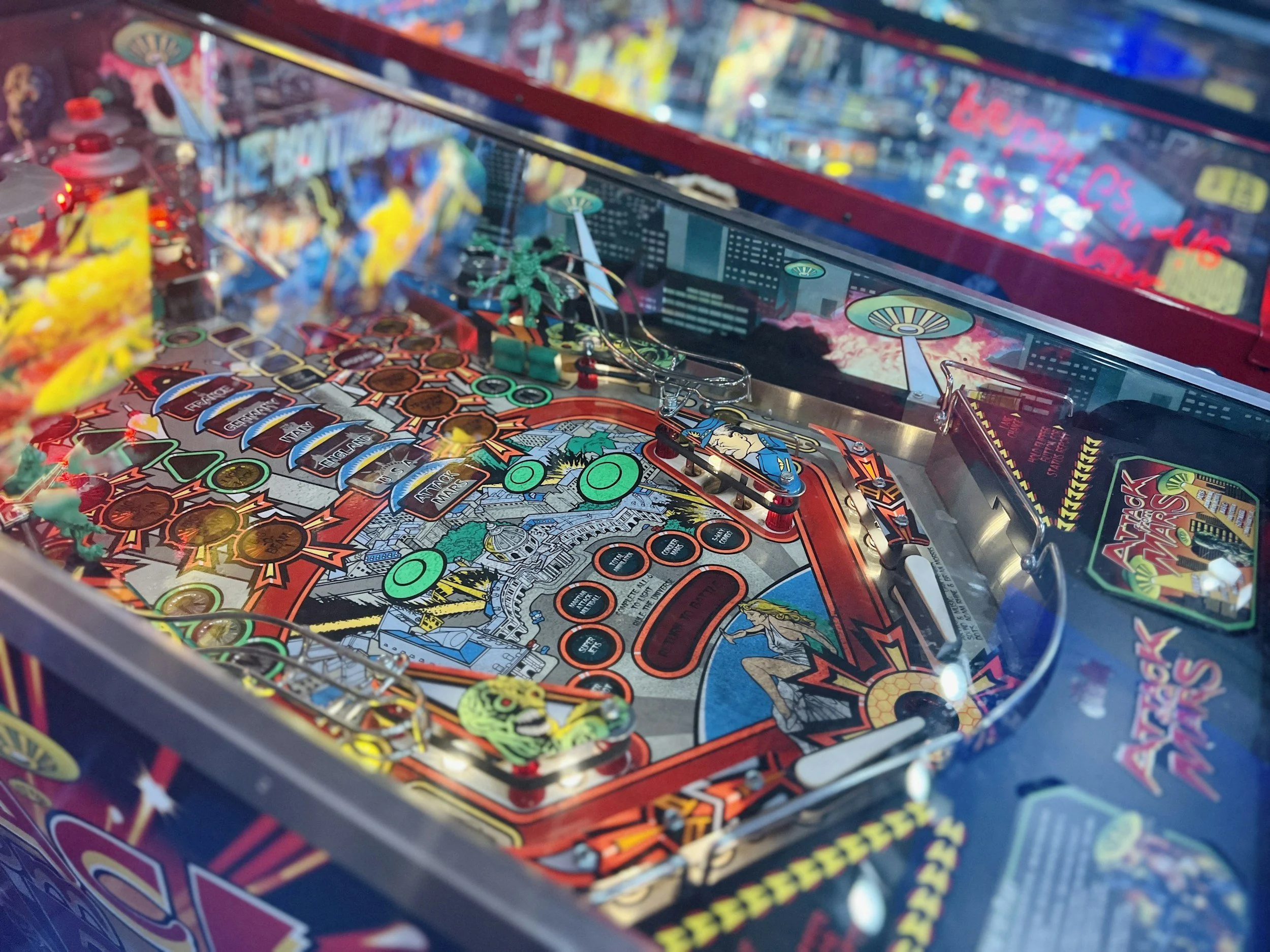 Close-up of a vintage pinball machine with colorful artwork and game components.