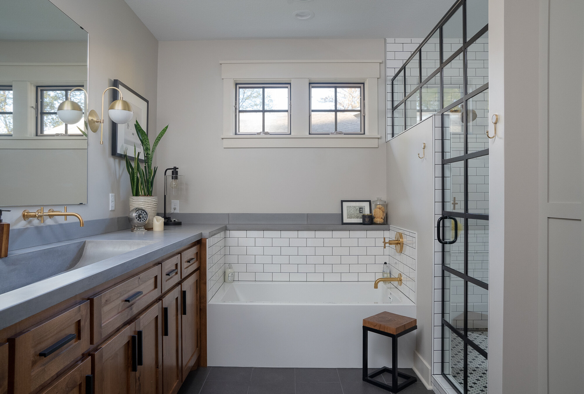Contemporary bathroom with subway tile and gold hardware