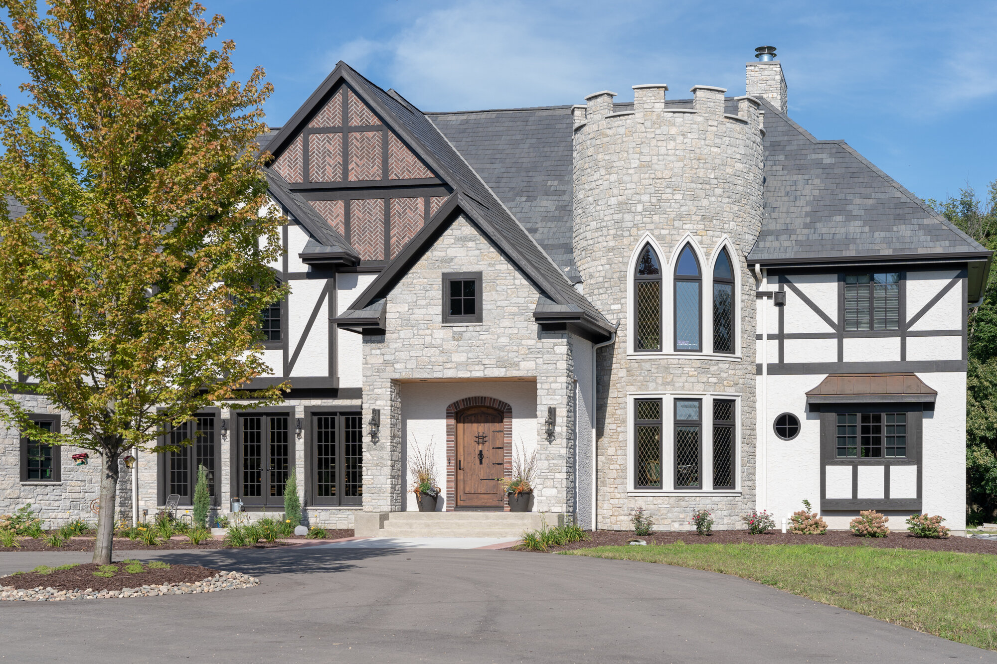 Contemporary home with stone turret